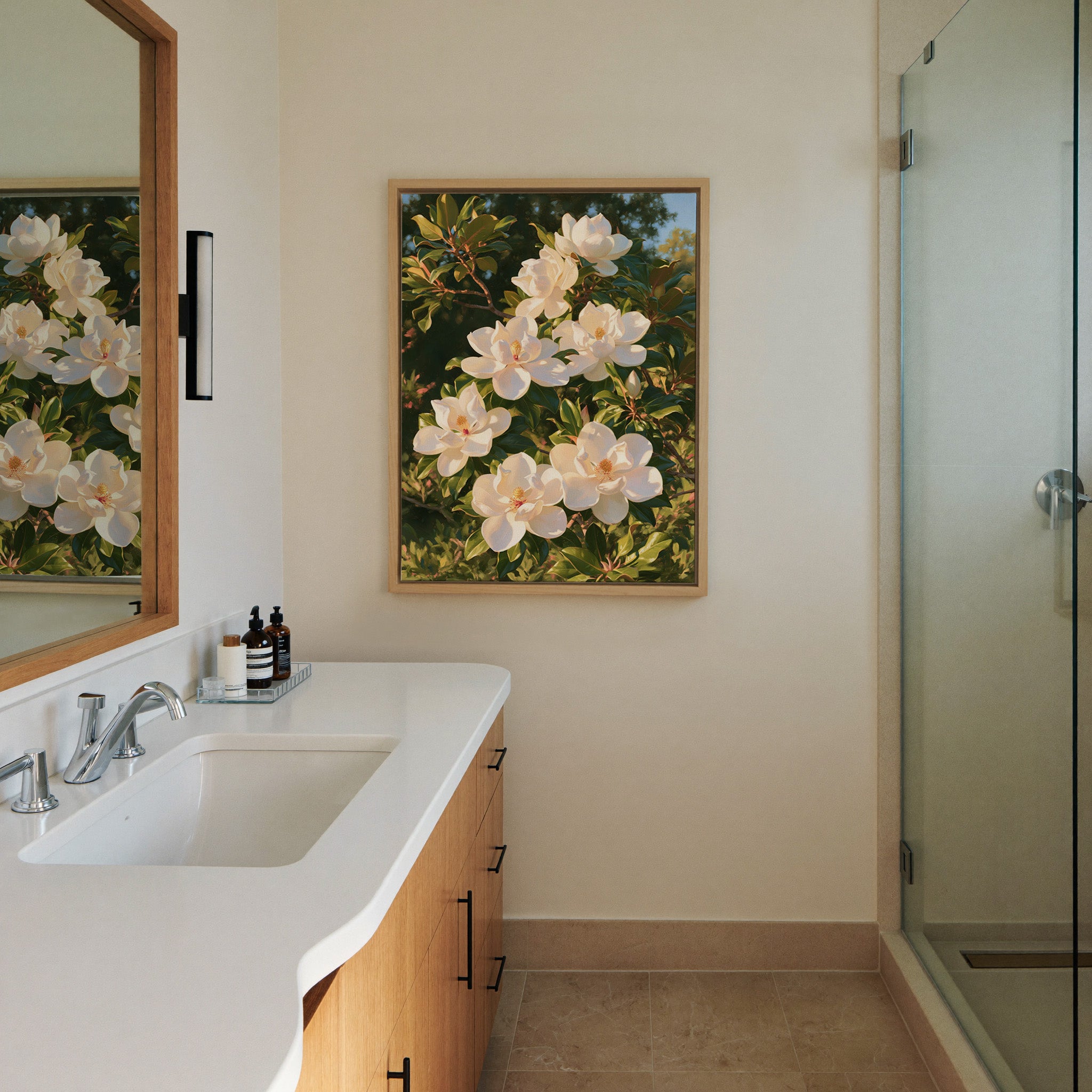 white magnolia blossoms with glossy green canvas wall art in a natural wood frame in a styled room setting