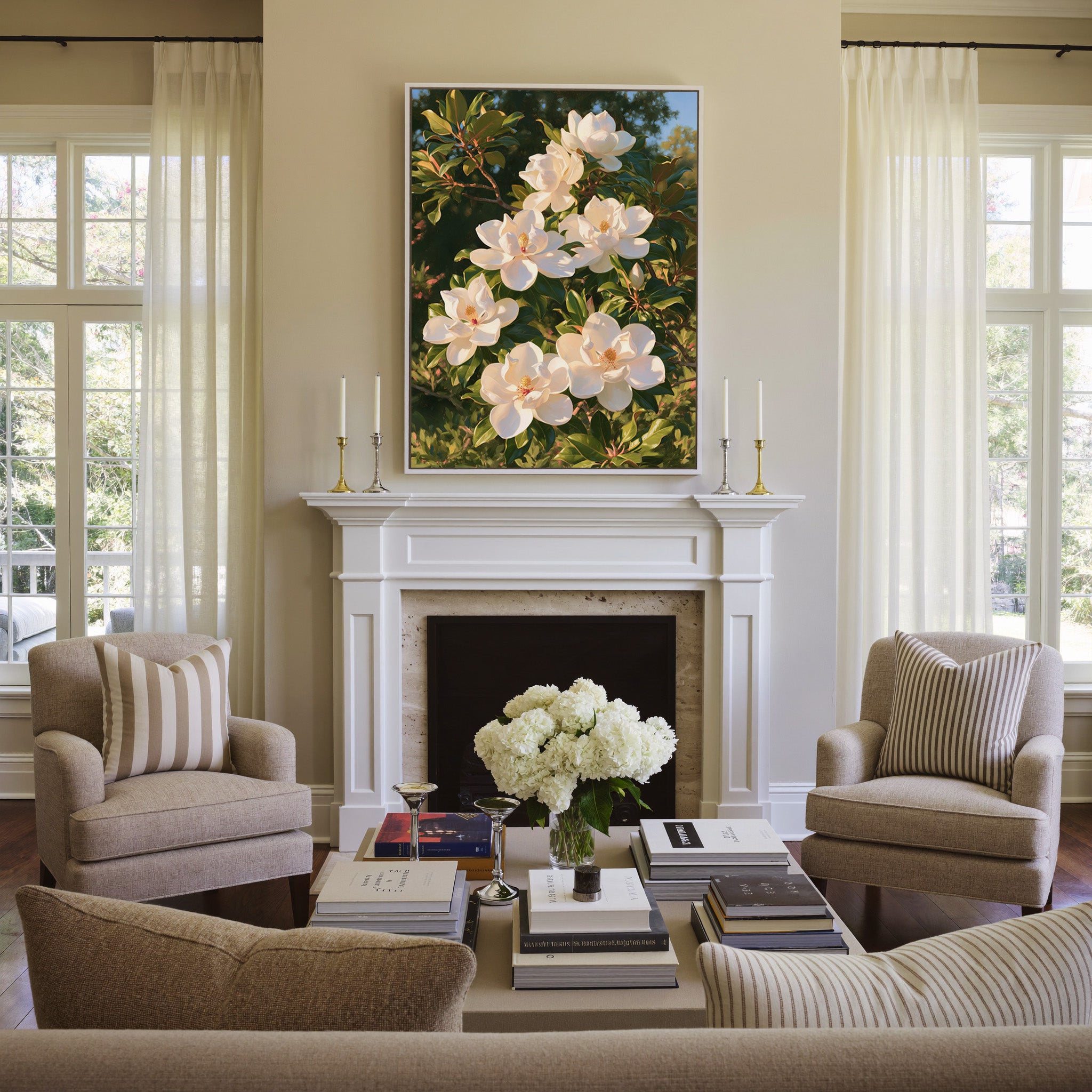 white magnolia blossoms with glossy green canvas wall art in a white frame above a mantel