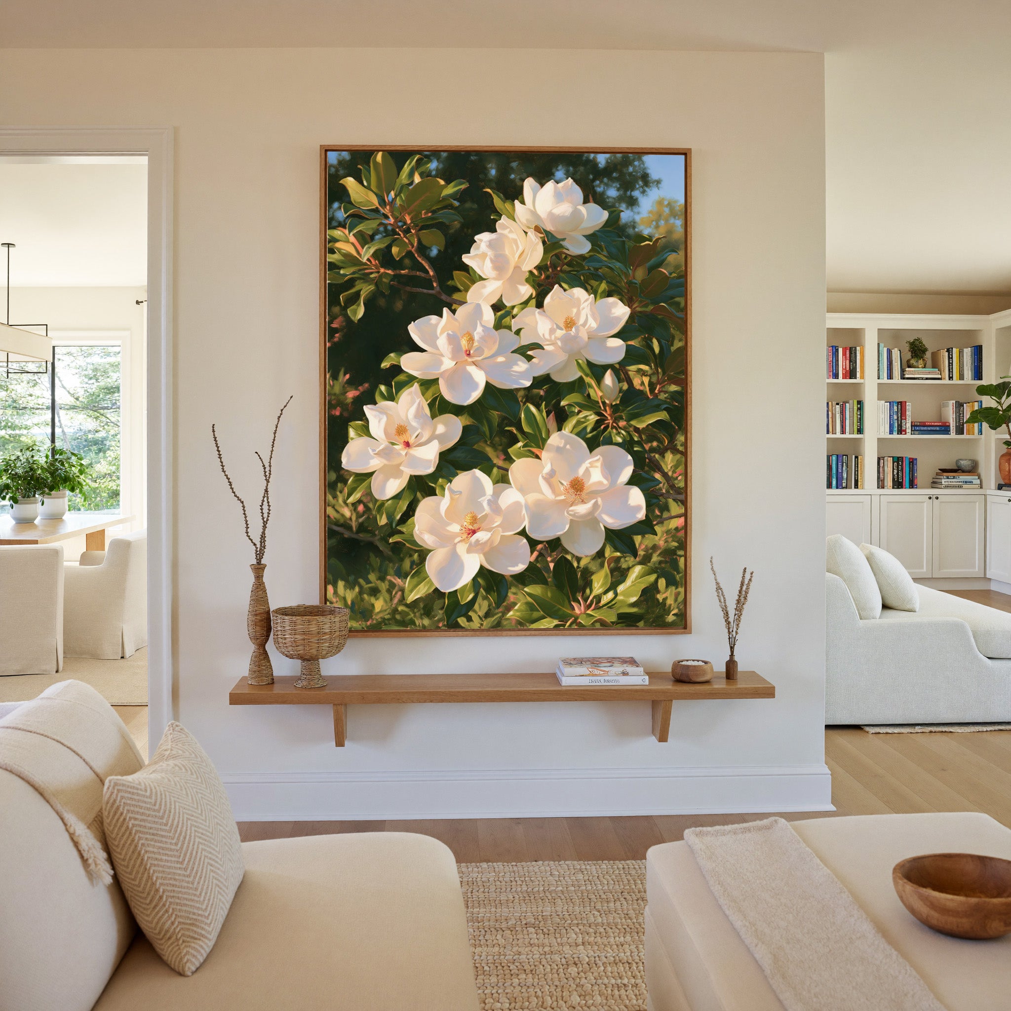 white magnolia blossoms with glossy green canvas wall art in an oak frame in a living room