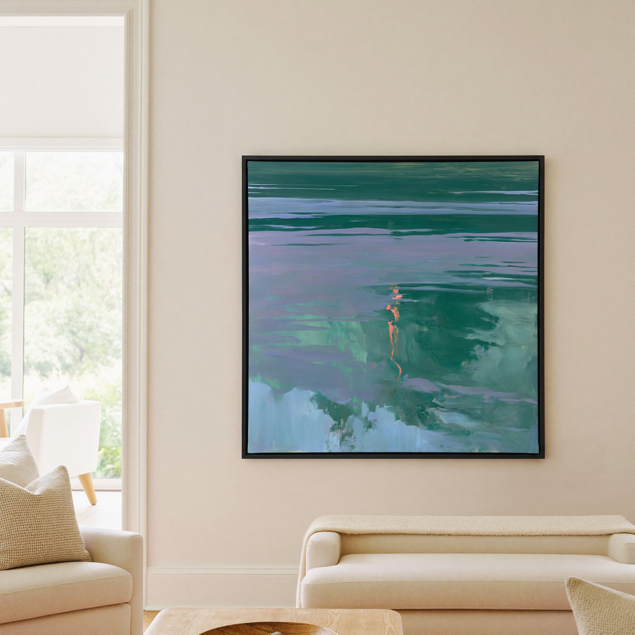 green and lavender abstract with coral canvas wall art in a black frame in a living room
