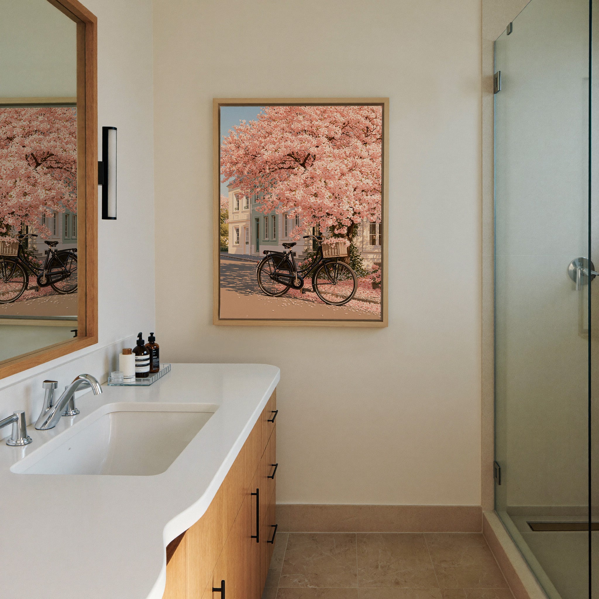 black bicycle beneath pink blossoms canvas wall art in a natural wood frame in a styled room setting