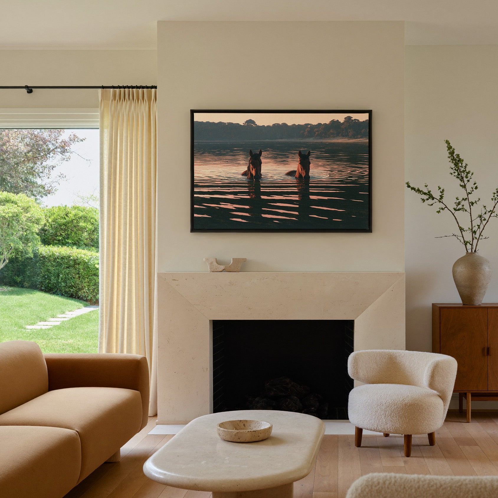 two brown horses wading in dark water at sunset canvas wall art in a black frame above a mantel