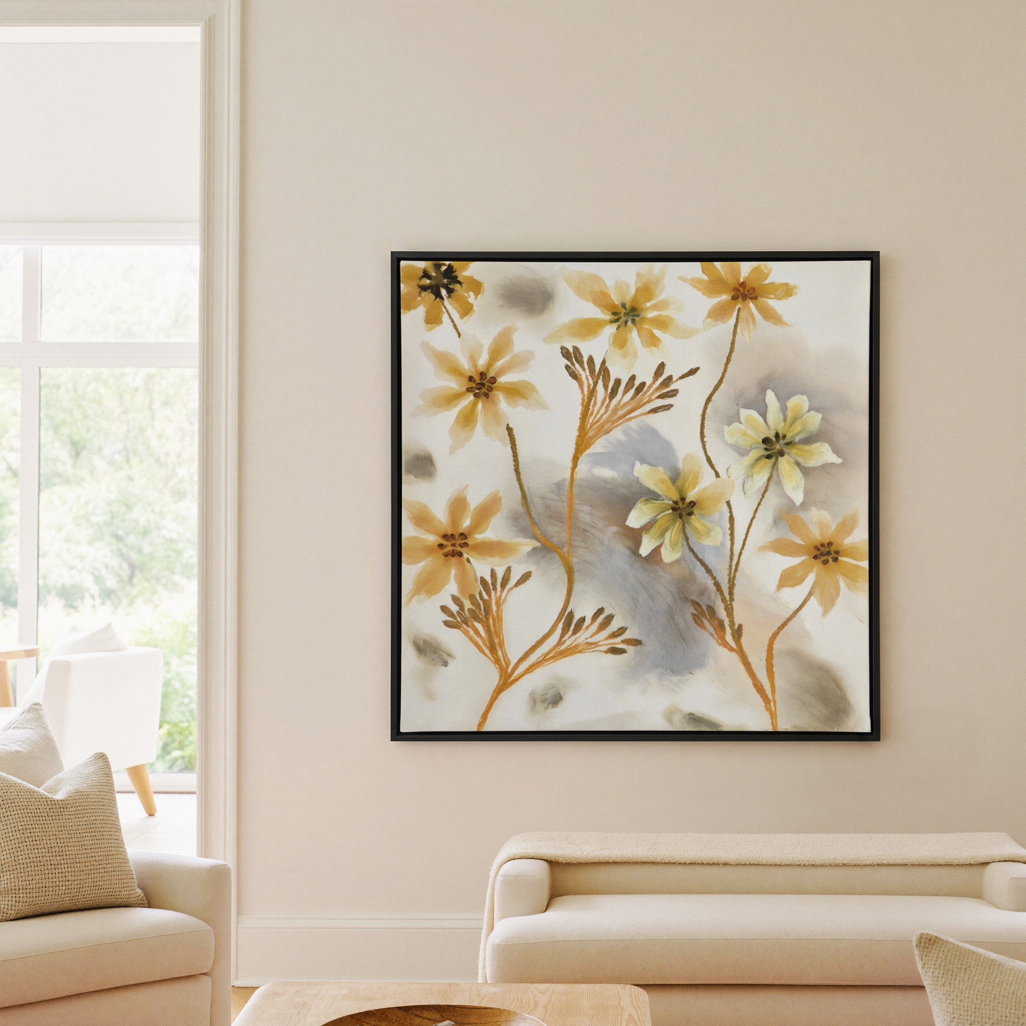 soft saffron and gray abstract floral forms canvas wall art in a black frame in a living room