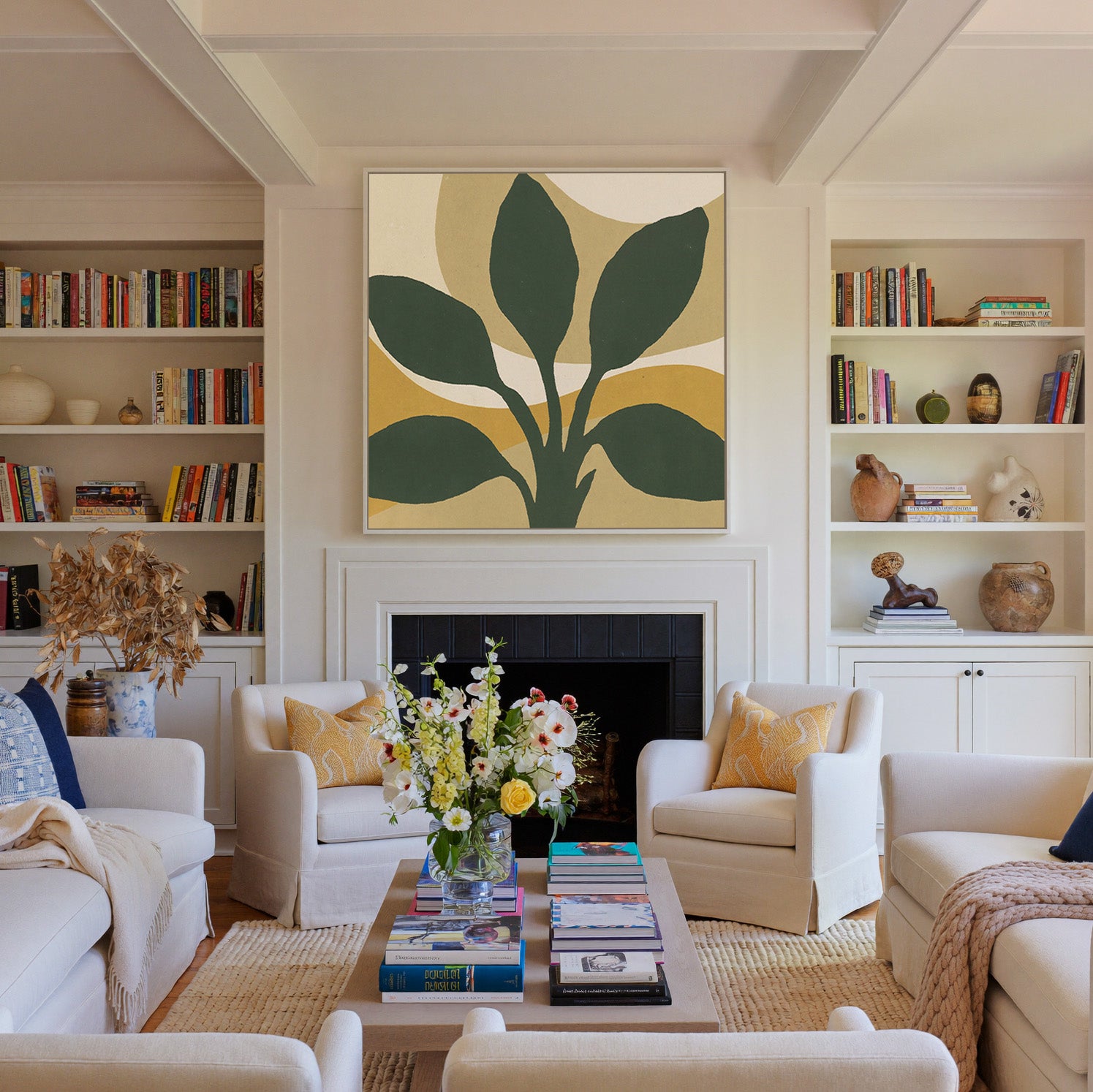 dark green leaf forms with warm ochre arcs canvas wall art in a white frame above a fireplace