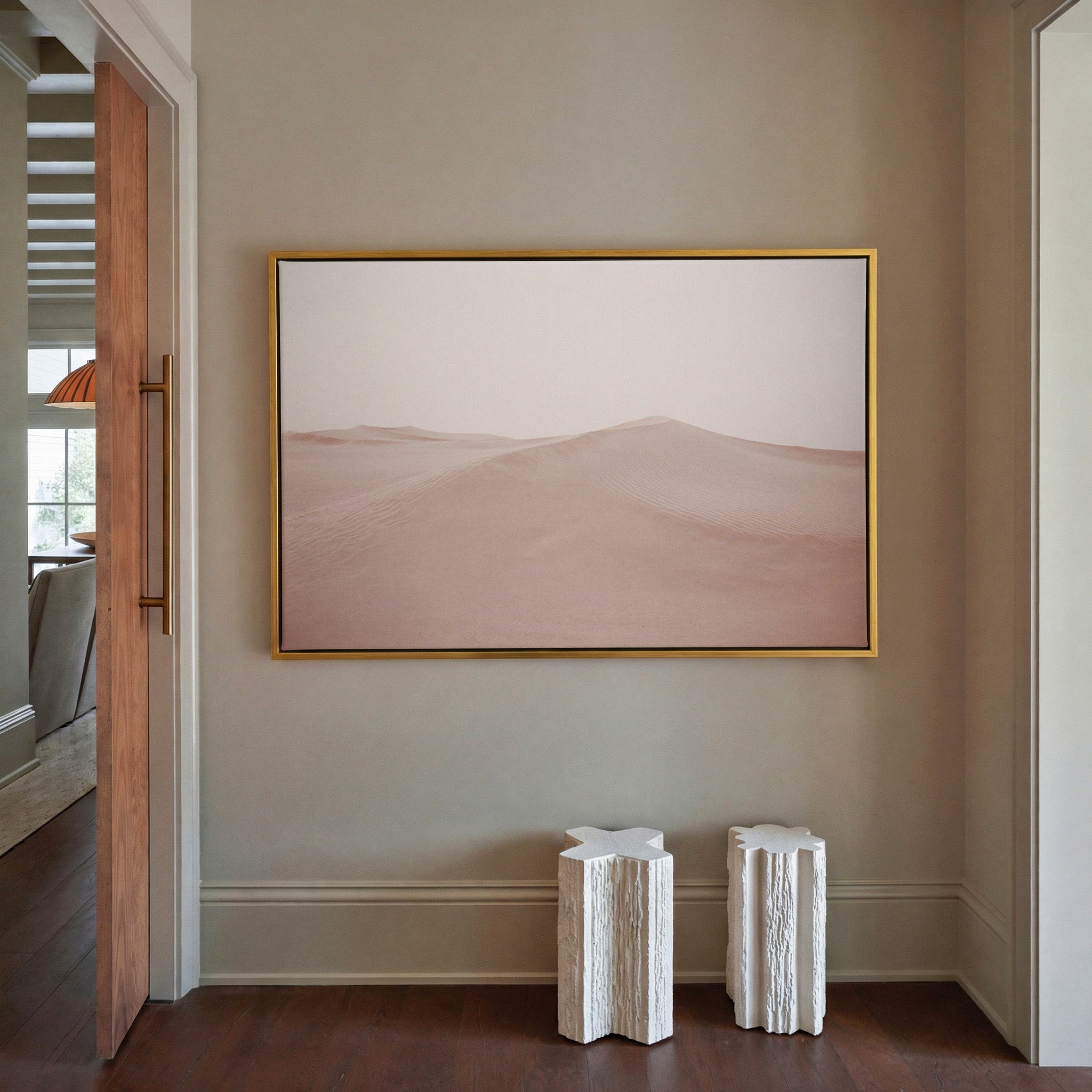 soft blush desert dunes canvas wall art in a gold frame in a styled room setting