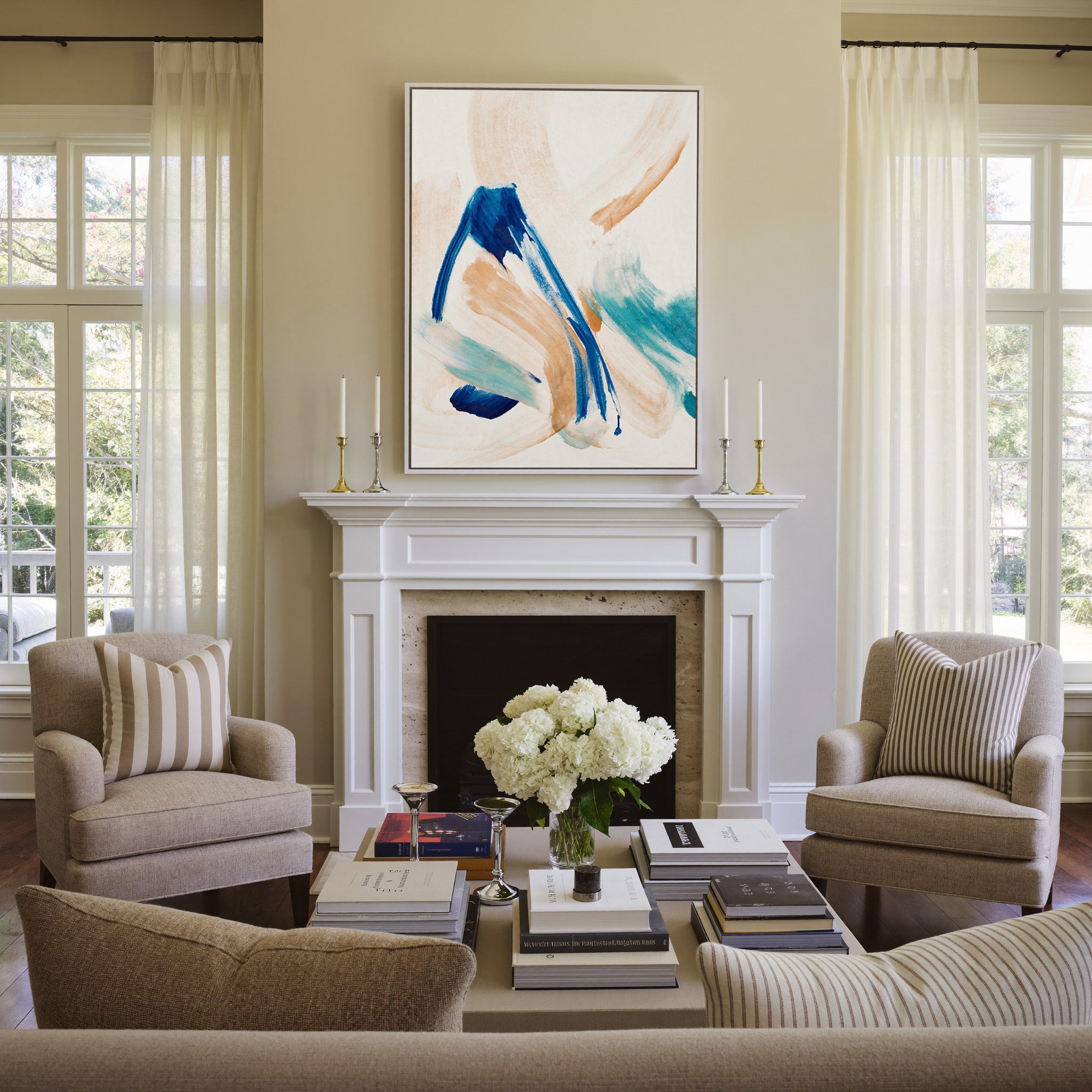blue, aqua, and warm beige abstract with canvas wall art in a white frame above a mantel