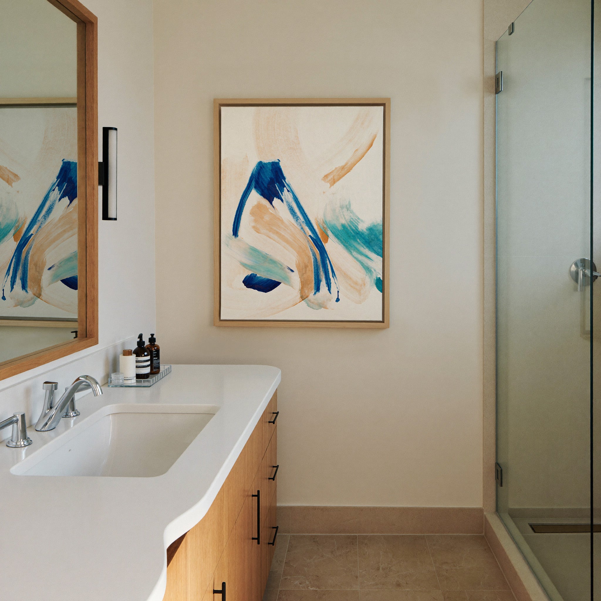 blue, aqua, and warm beige abstract with canvas wall art in a natural wood frame in a styled room setting