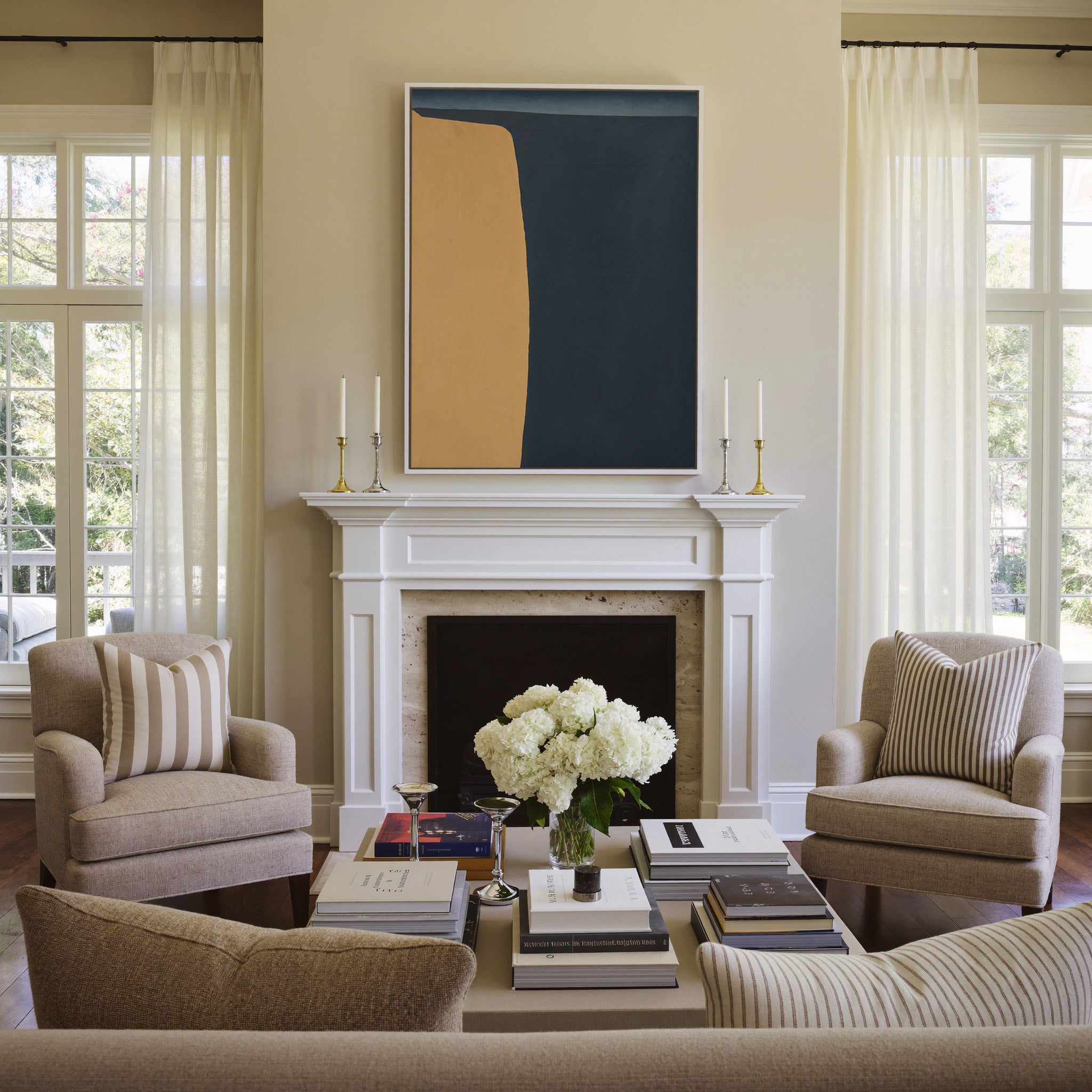 navy and ochre abstract with a tall curved block canvas wall art in a white frame above a mantel