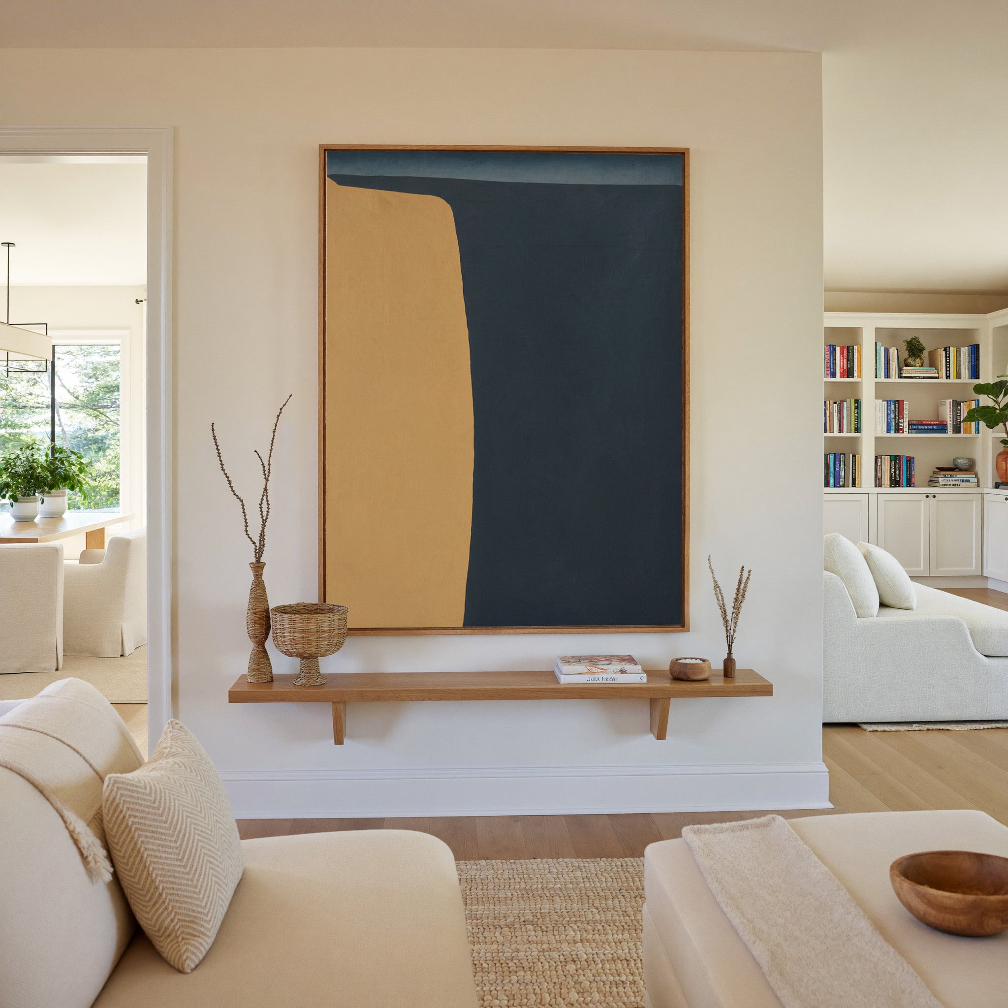 navy and ochre abstract with a tall curved block canvas wall art in an oak frame in a living room