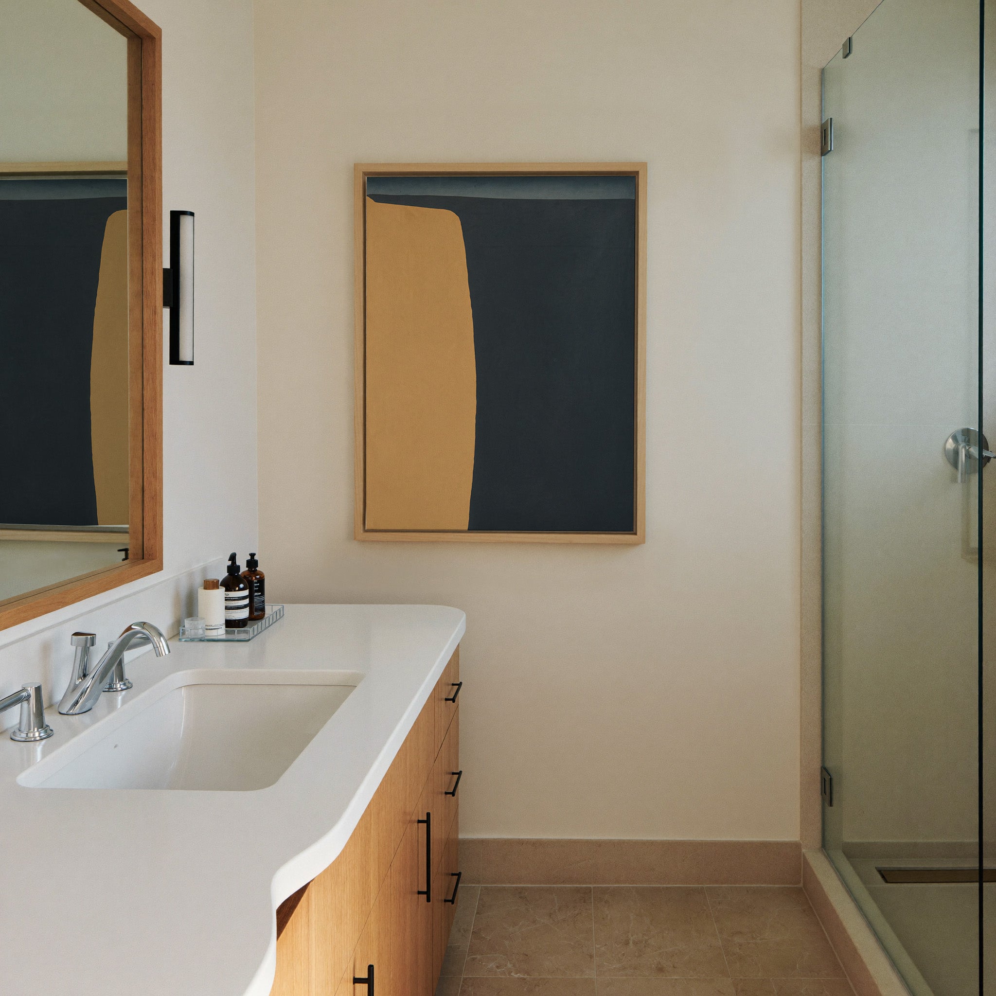 navy and ochre abstract with a canvas wall art in a natural wood frame in a styled room setting