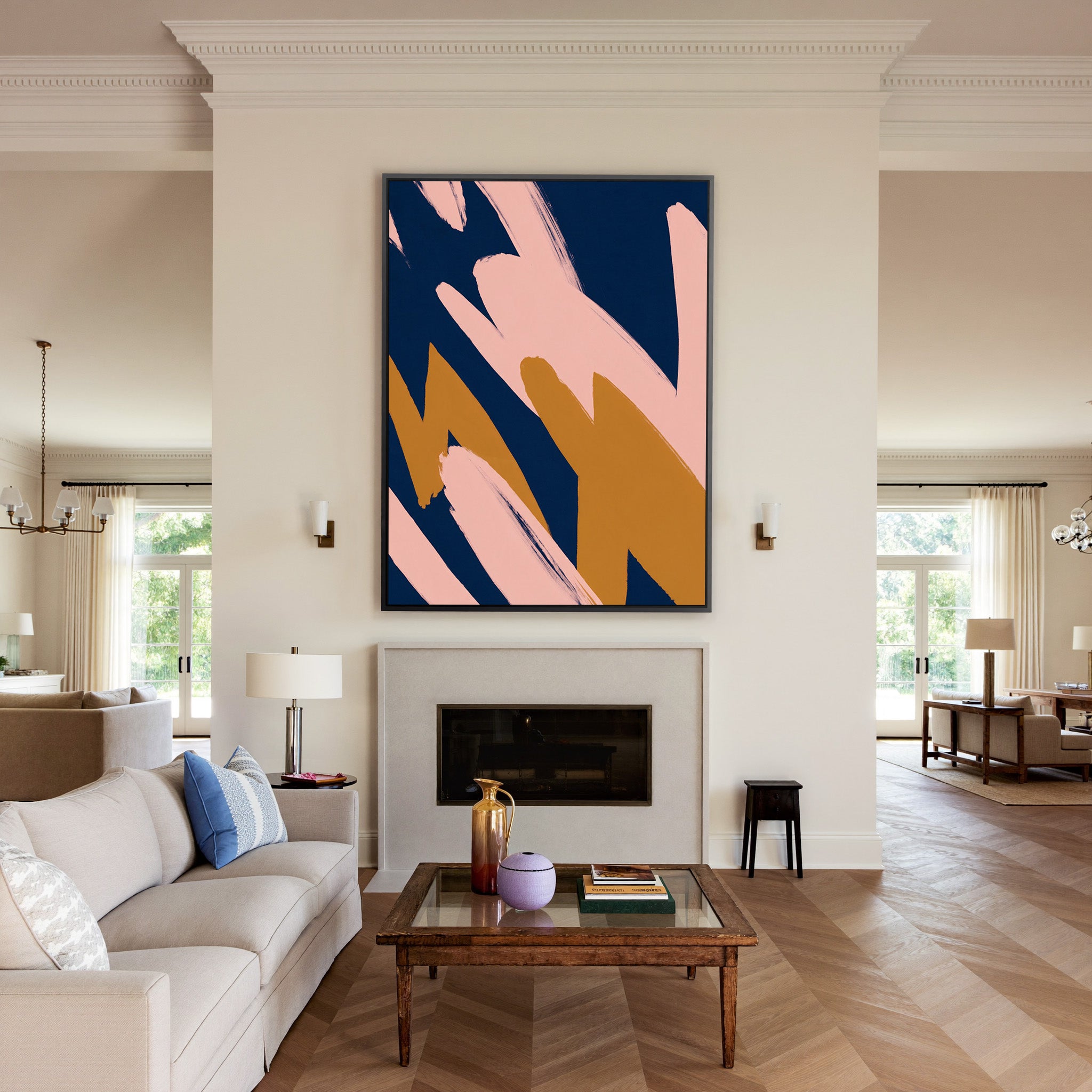 navy abstract with blush and ochre brush shapes canvas wall art in a black frame above a mantel