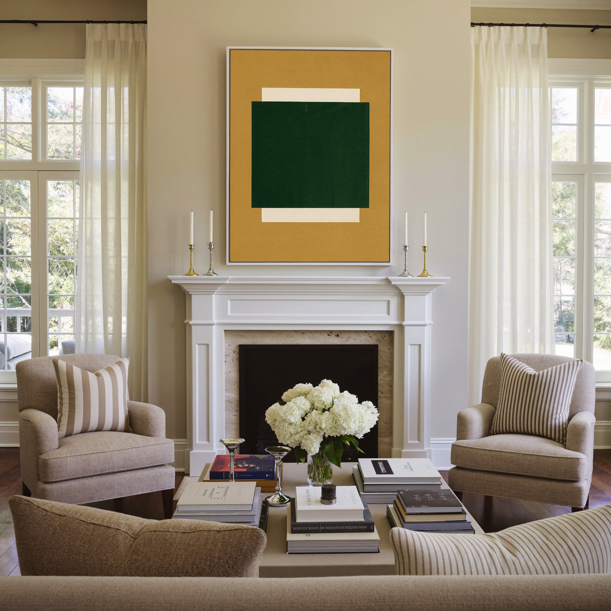 deep green block on ochre ground canvas wall art in a white frame above a mantel