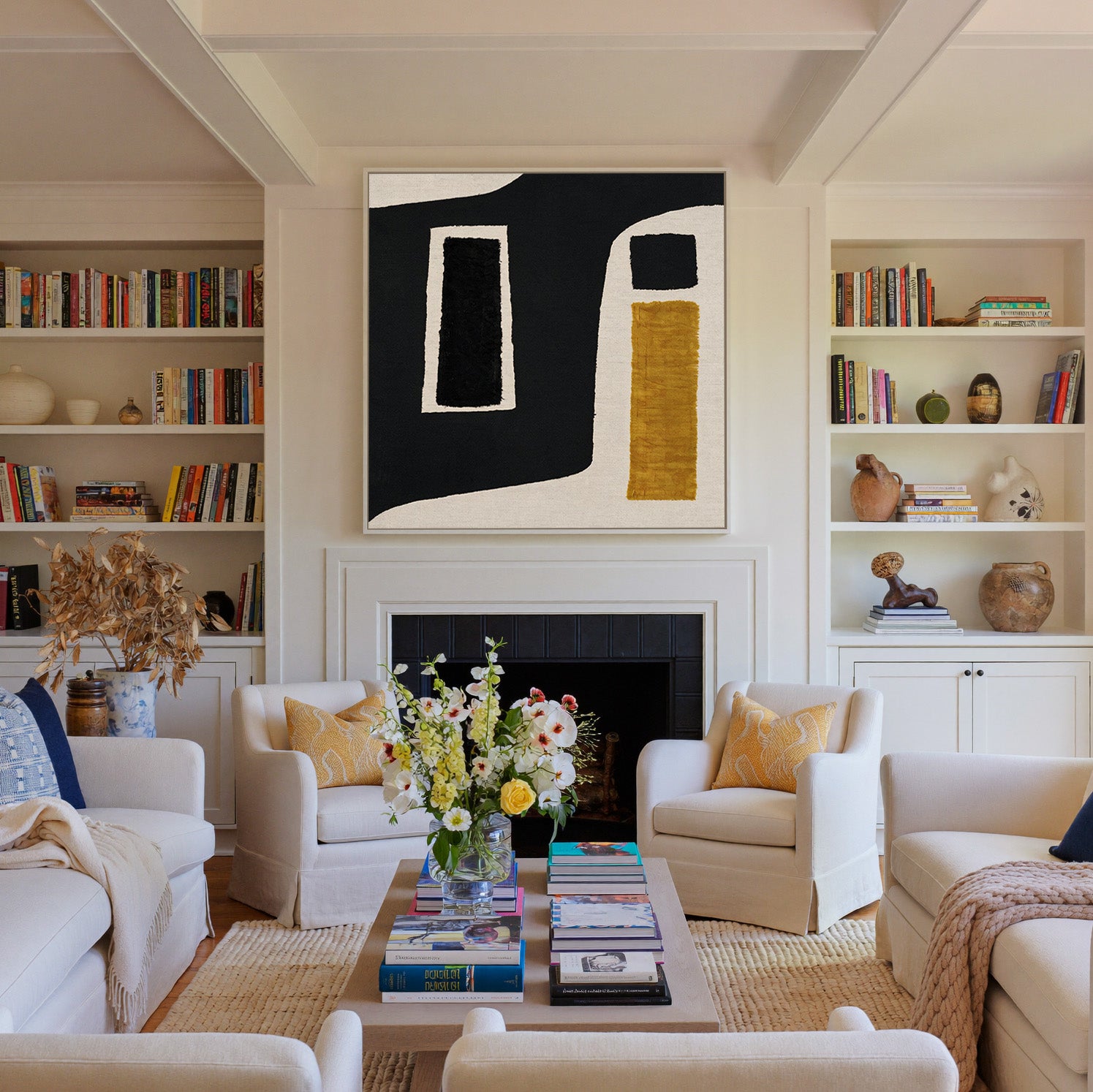 black and ochre abstract with framed blocks canvas wall art in a white frame above a fireplace
