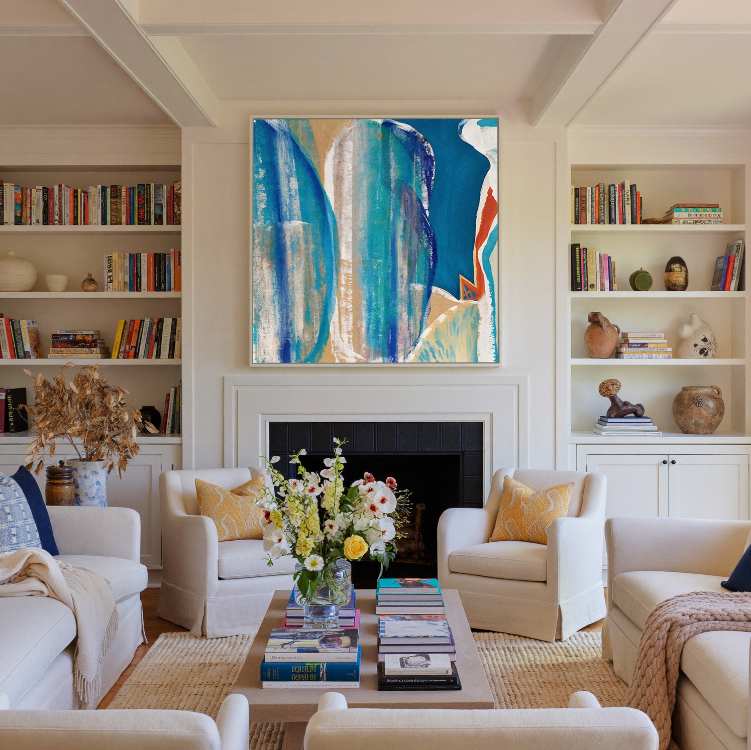 blue and turquoise abstract with cream bands canvas wall art in a white frame above a fireplace