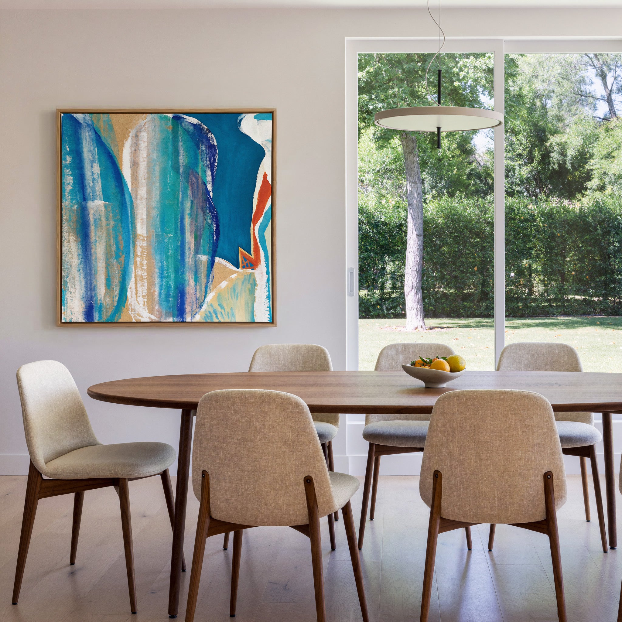 blue and turquoise abstract with cream bands canvas wall art in an oak frame in a dining room