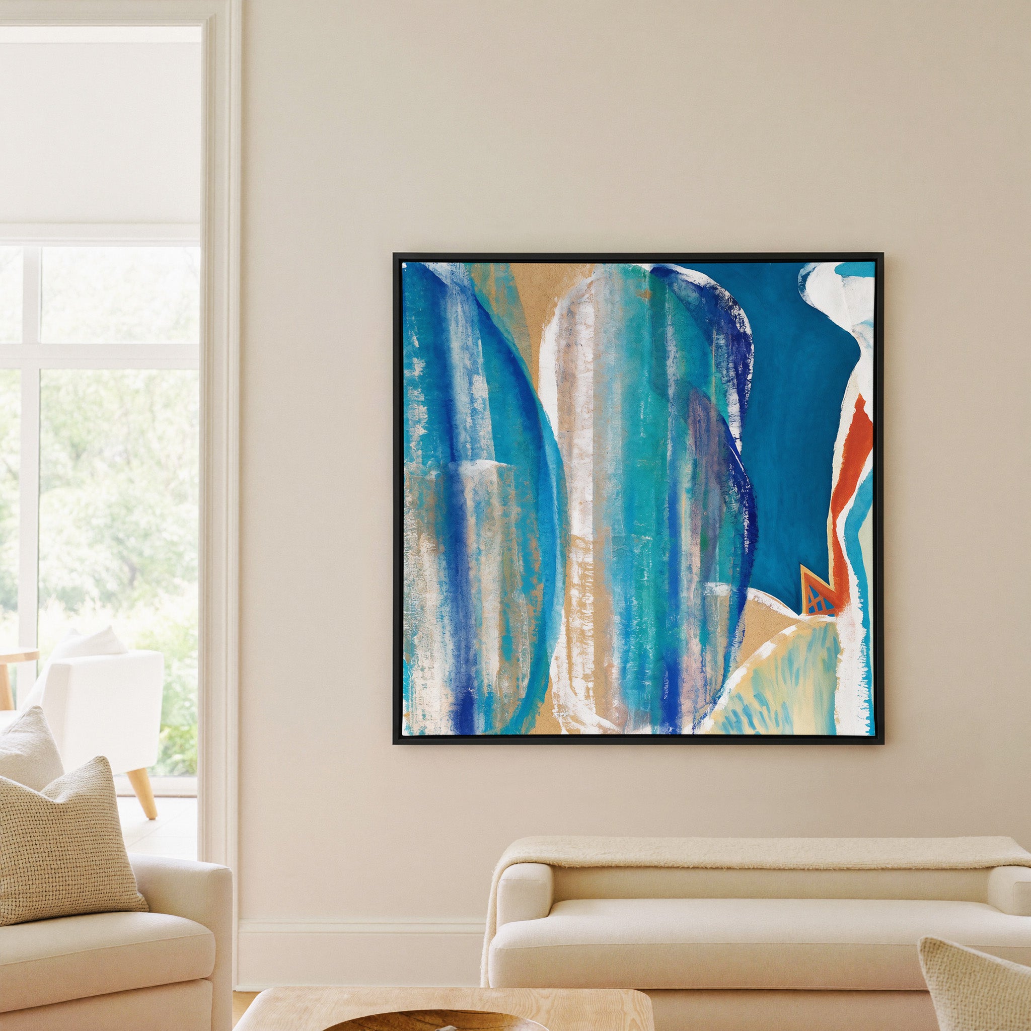 blue and turquoise abstract with cream bands canvas wall art in a black frame in a living room