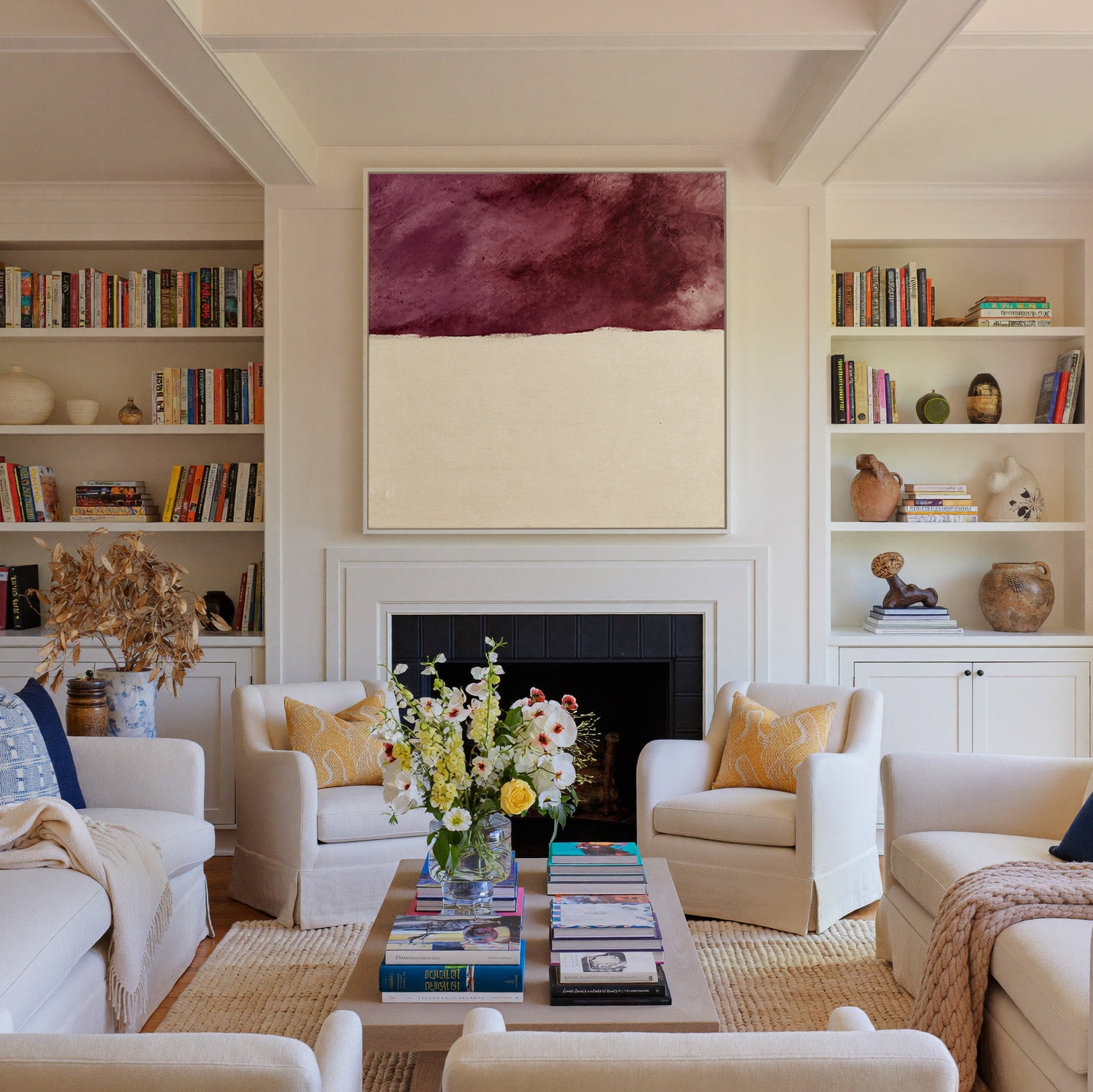 deep plum and cream abstract canvas wall art in a white frame above a fireplace