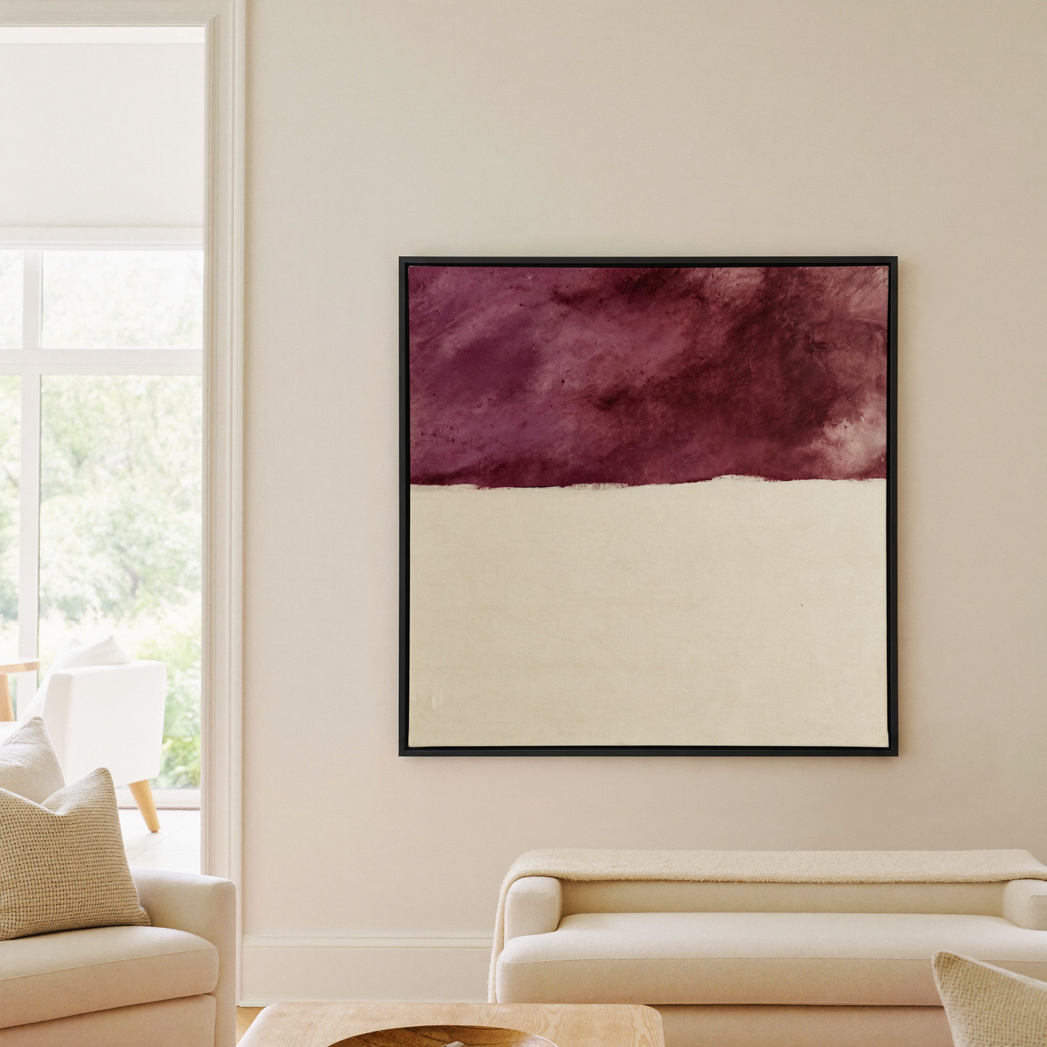 deep plum and cream abstract canvas wall art in a black frame in a living room