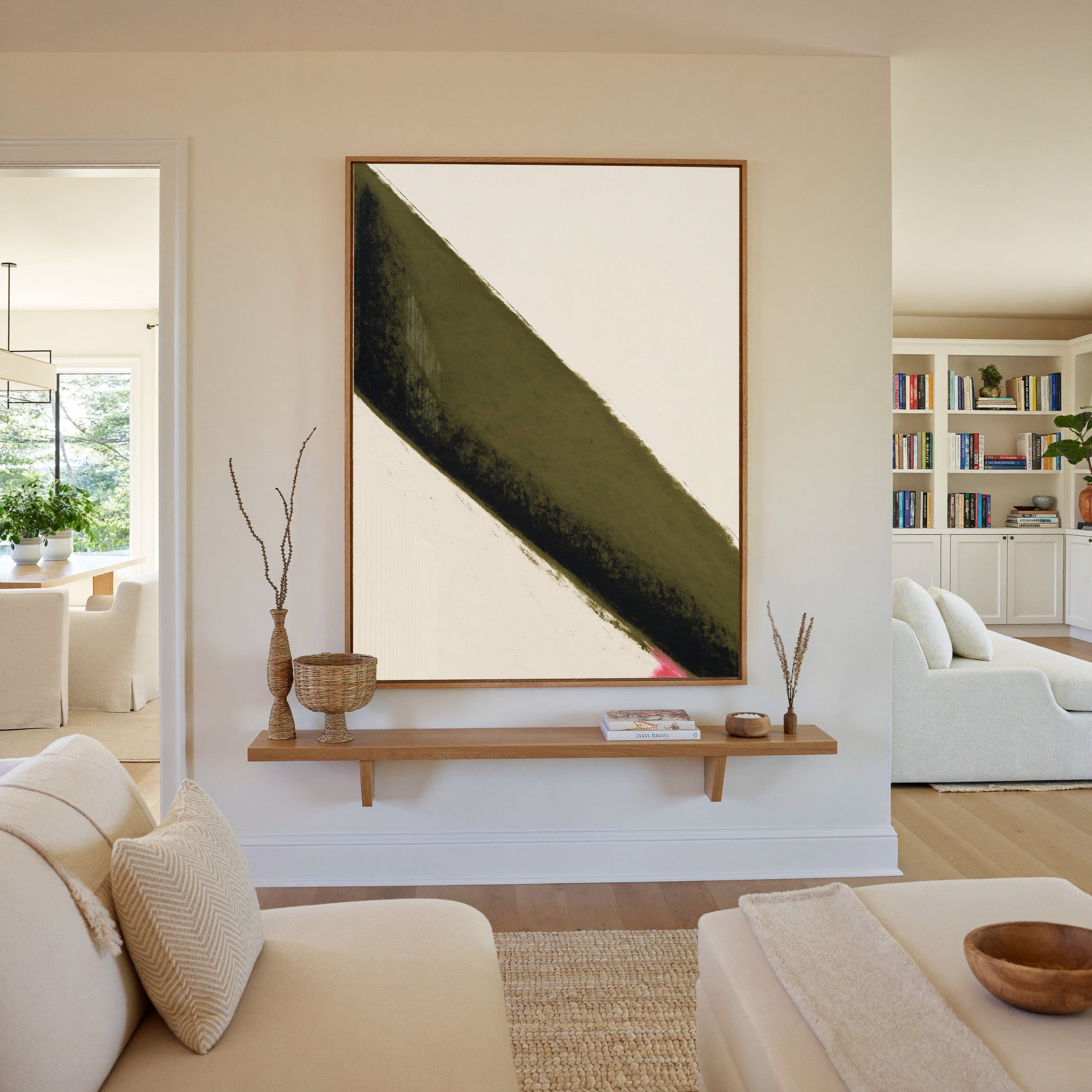 olive green diagonal band with black edge and canvas wall art in an oak frame in a living room