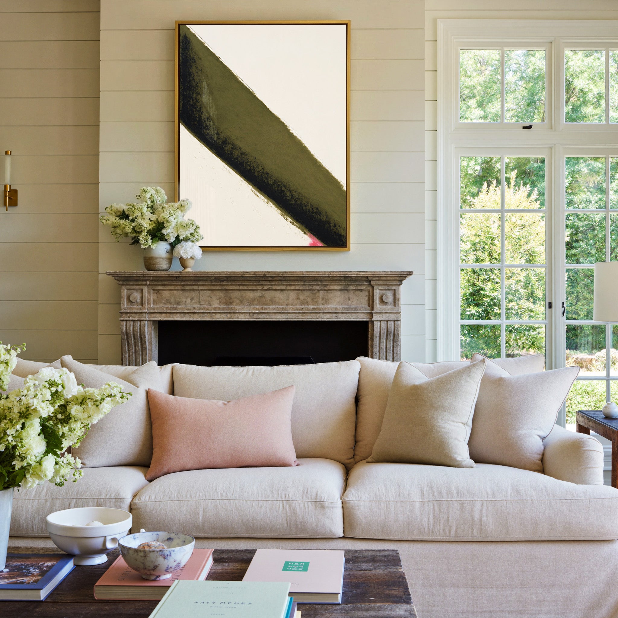 olive green diagonal band with black edge and canvas wall art in a gold frame above a mantel