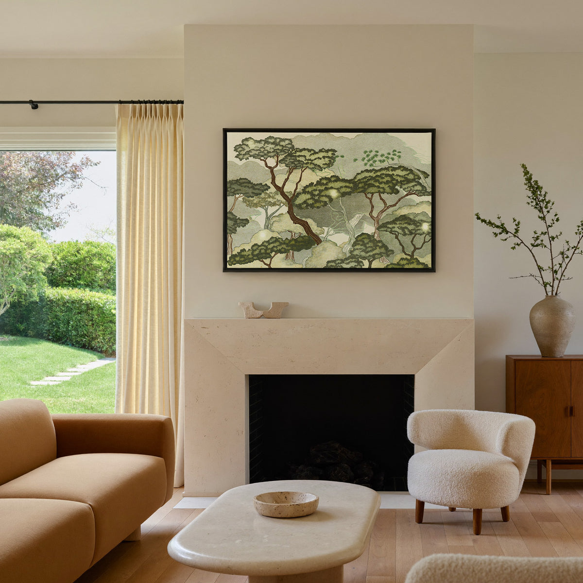 layered trees with pale green clouds and canvas wall art in a black frame above a mantel