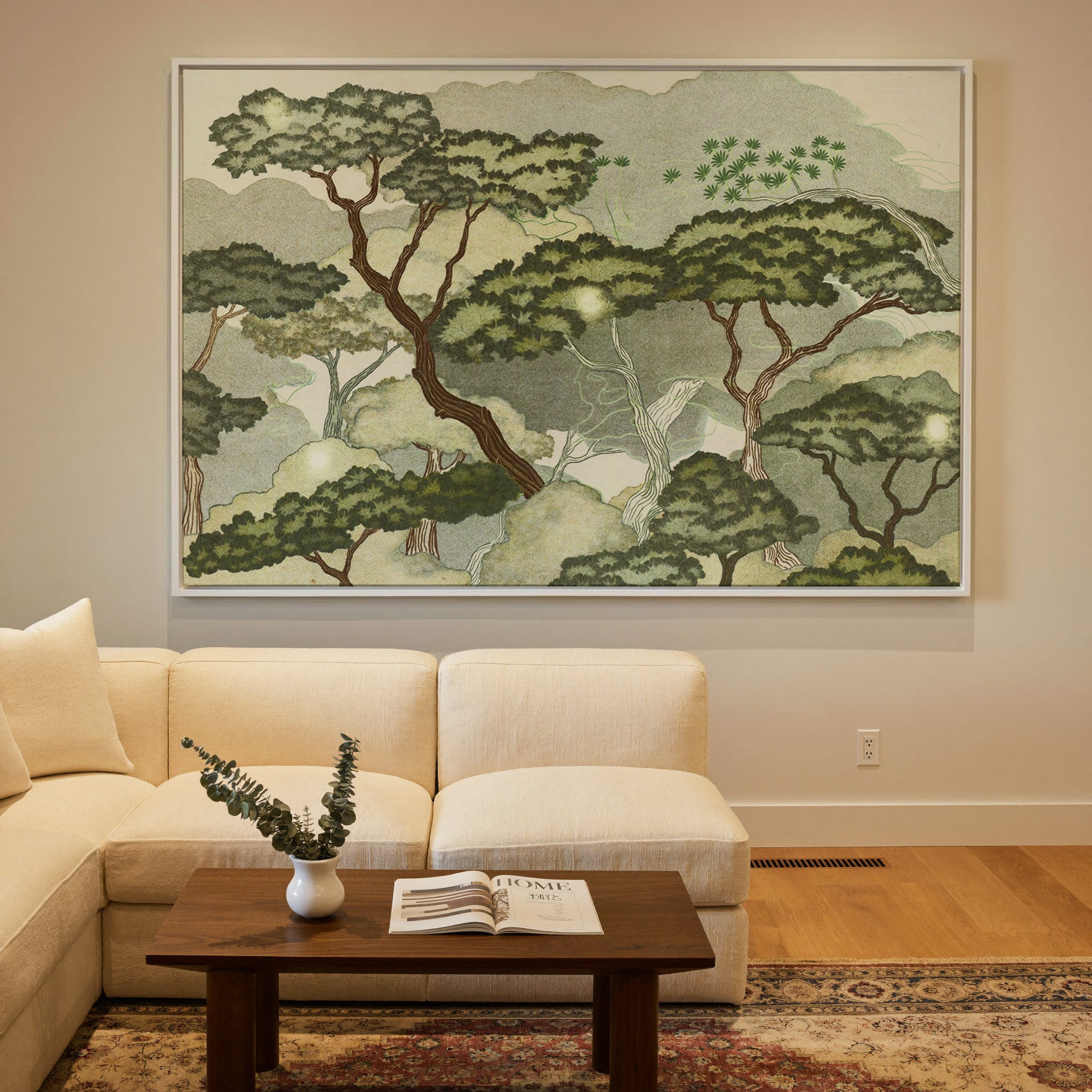 layered trees with pale green clouds and canvas wall art in a white frame in a styled room setting
