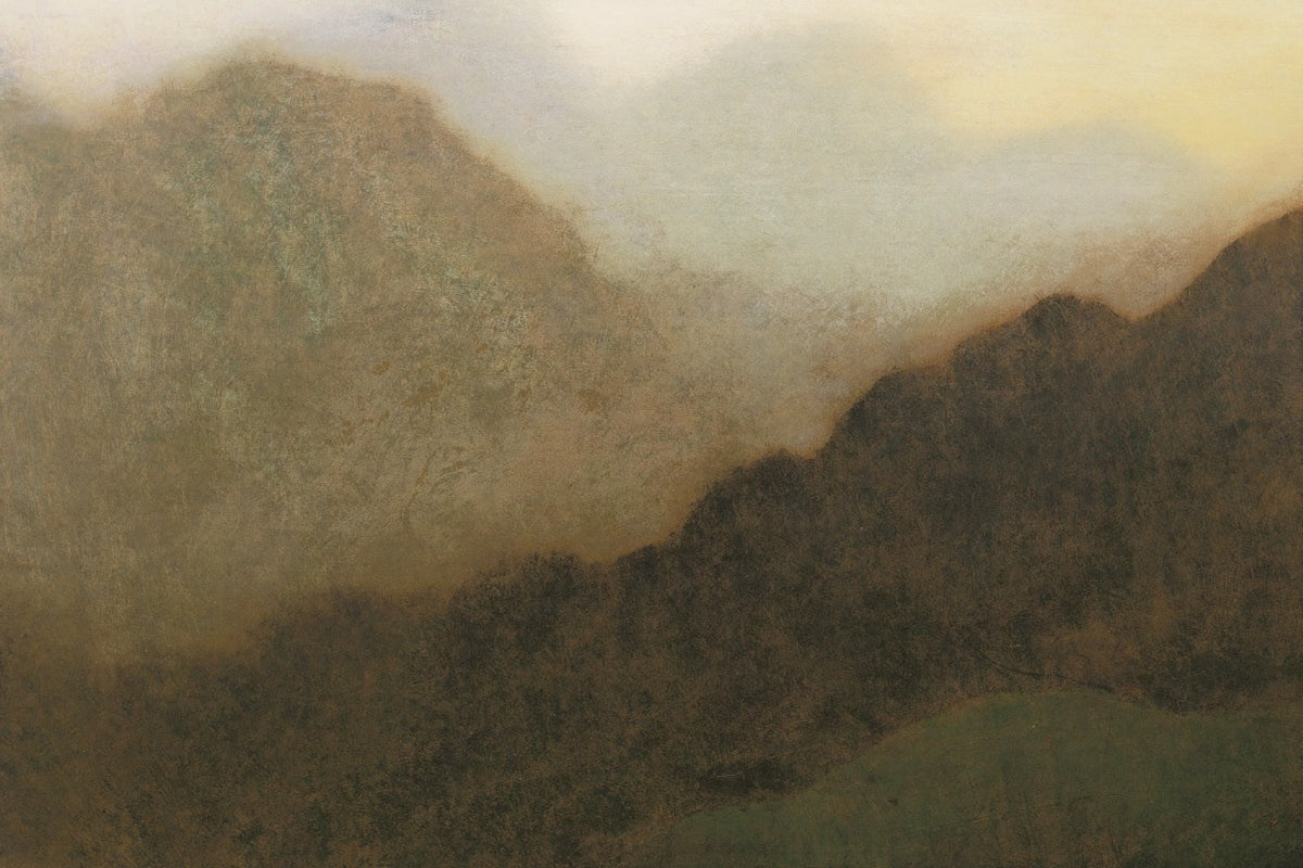 Misty brown mountain slopes with a dark central band and pale cream sky above
