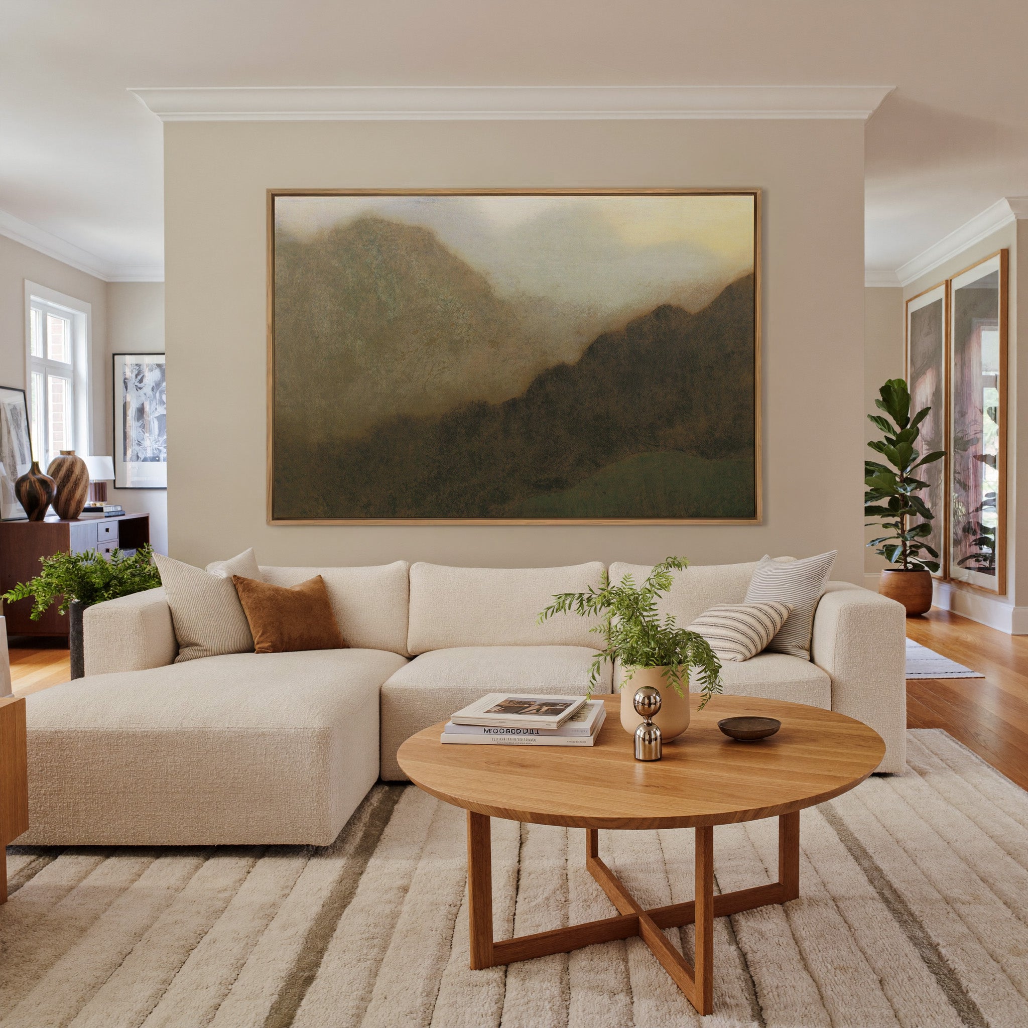 misty brown mountain landscape canvas wall art in an oak frame in a living room