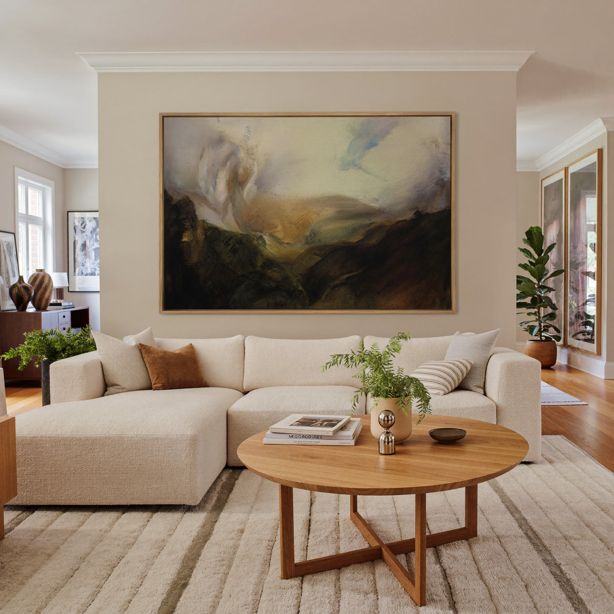 misty mountain landscape with dark foreground canvas wall art in an oak frame in a living room