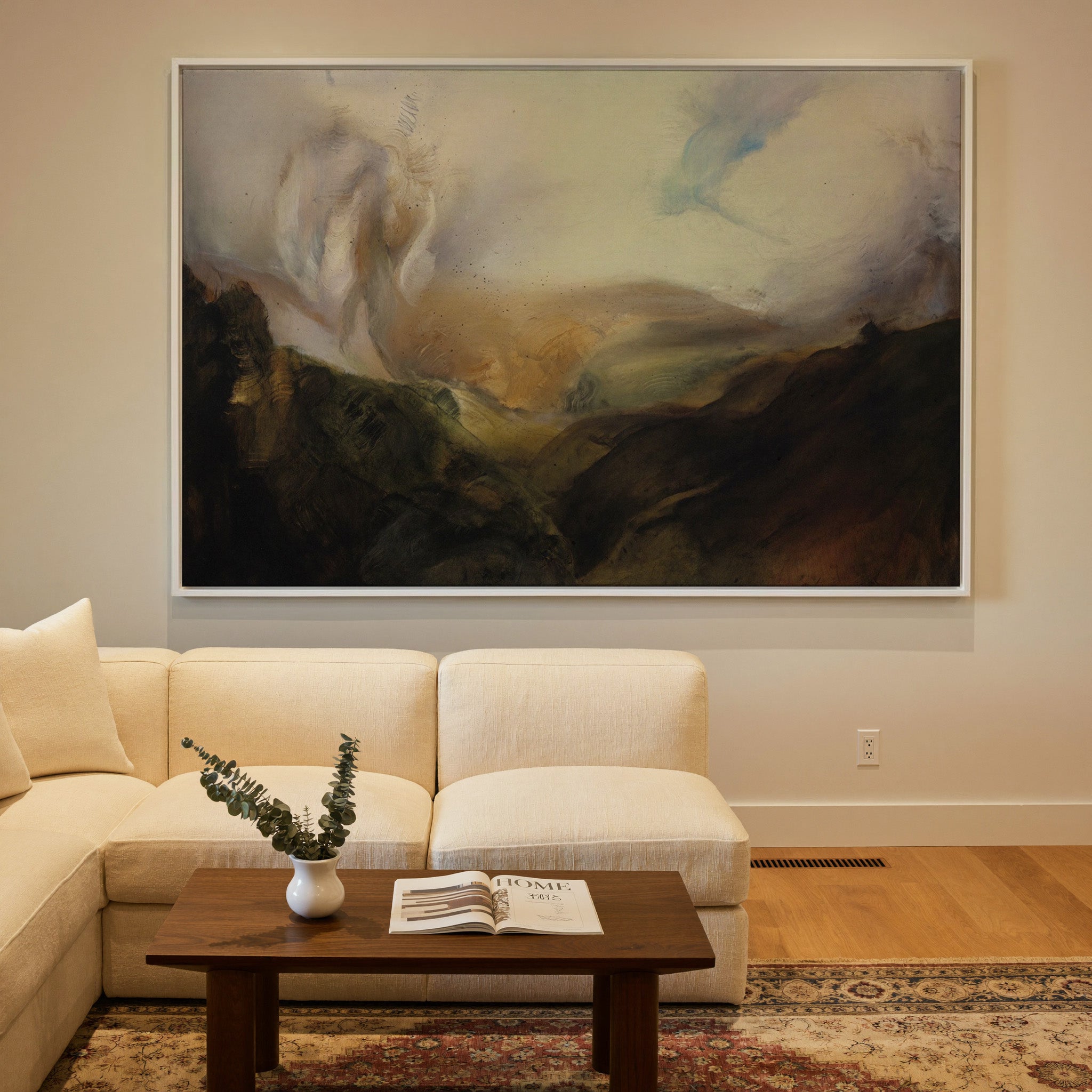 misty mountain landscape with dark foreground canvas wall art in a white frame in a styled room setting