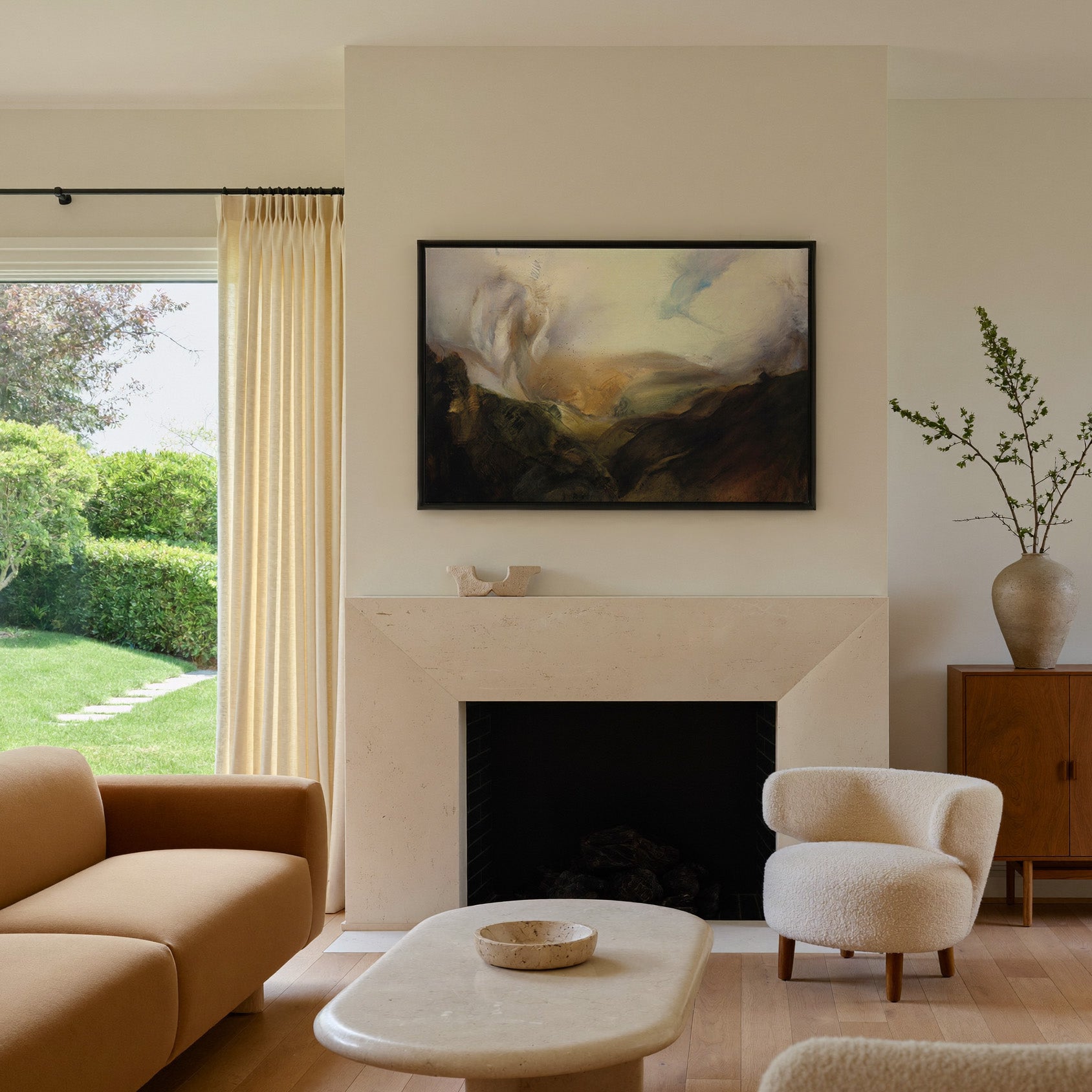 misty mountain landscape with dark foreground canvas wall art in a black frame above a mantel