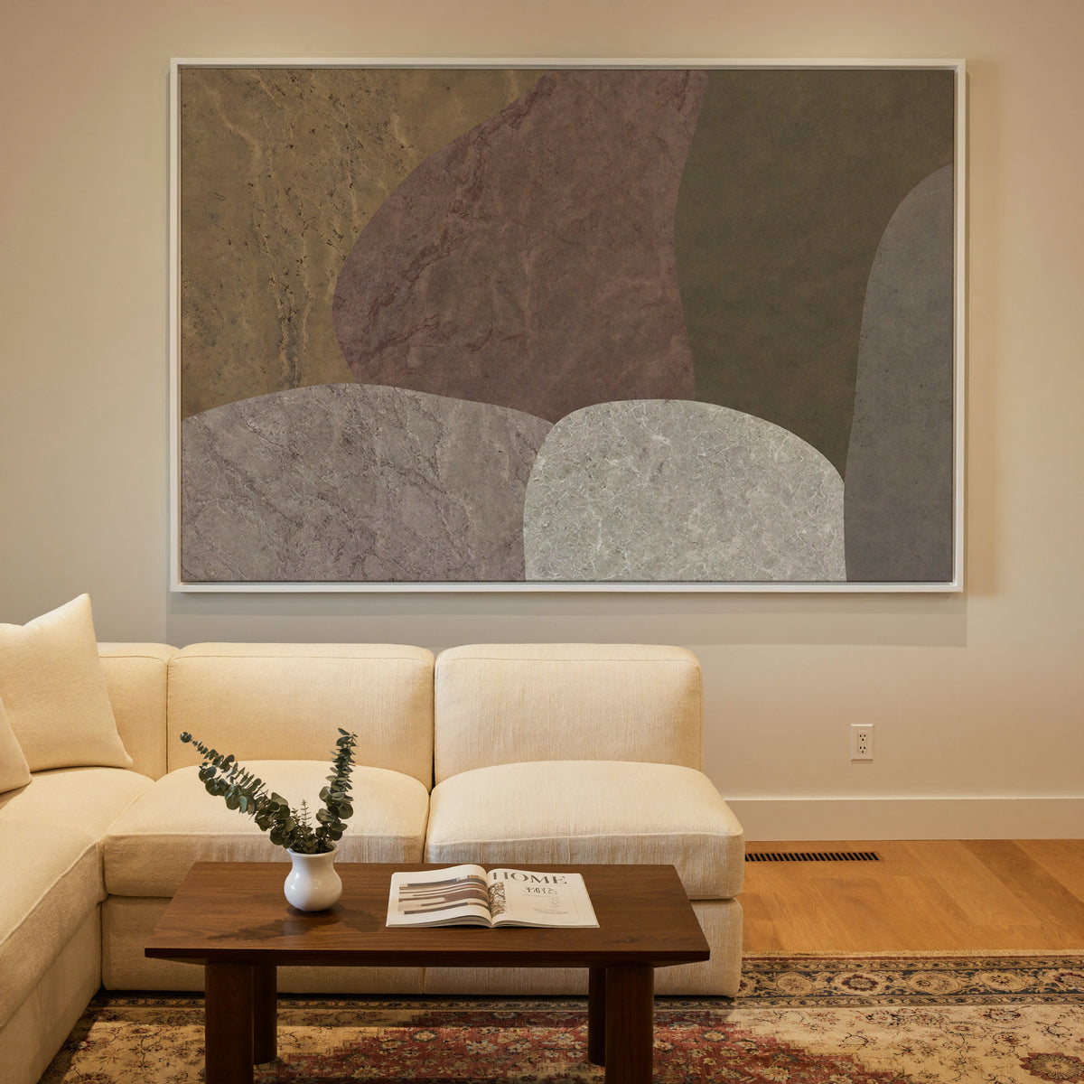 earthy abstract with arched stone like forms canvas wall art in a white frame in a styled room setting