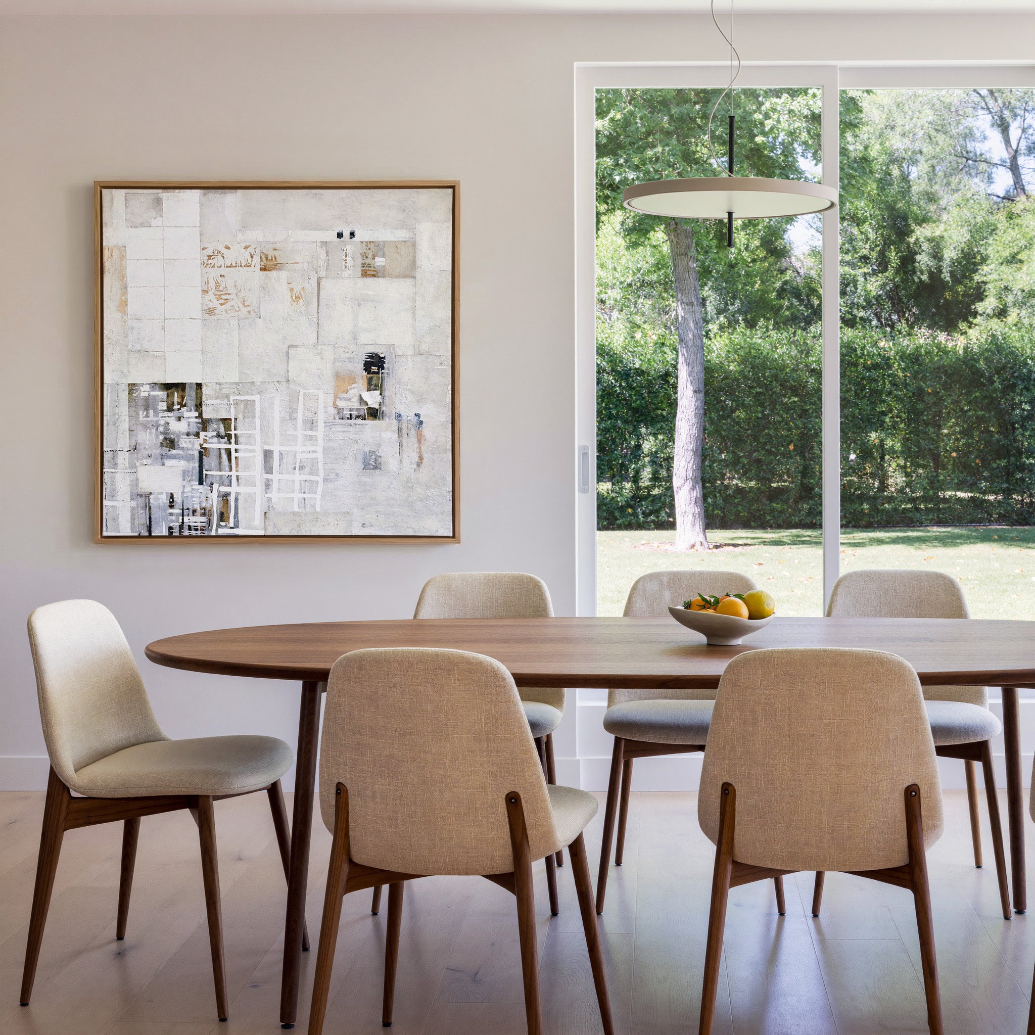 soft white and warm gray abstract with layered canvas wall art in an oak frame in a dining room