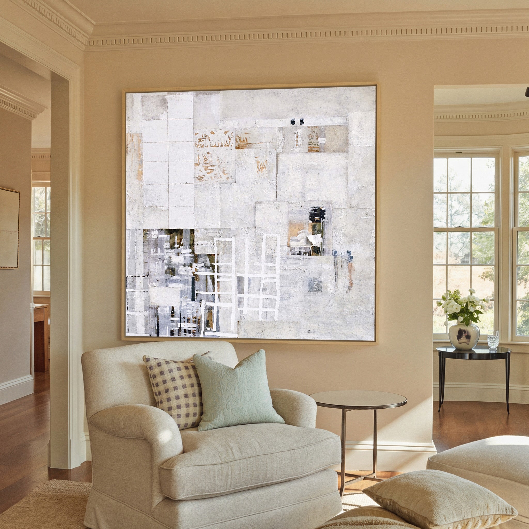 soft white and warm gray abstract canvas wall art in a natural wood frame in a styled room setting