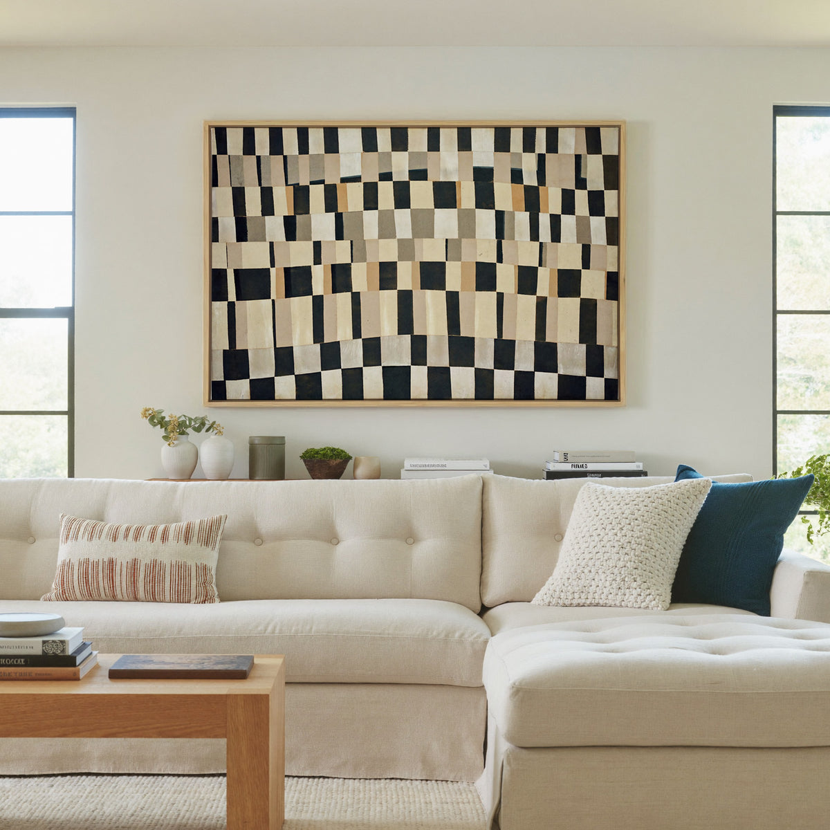 curved black, cream, and tan checker abstract canvas wall art in a natural wood frame in a living room