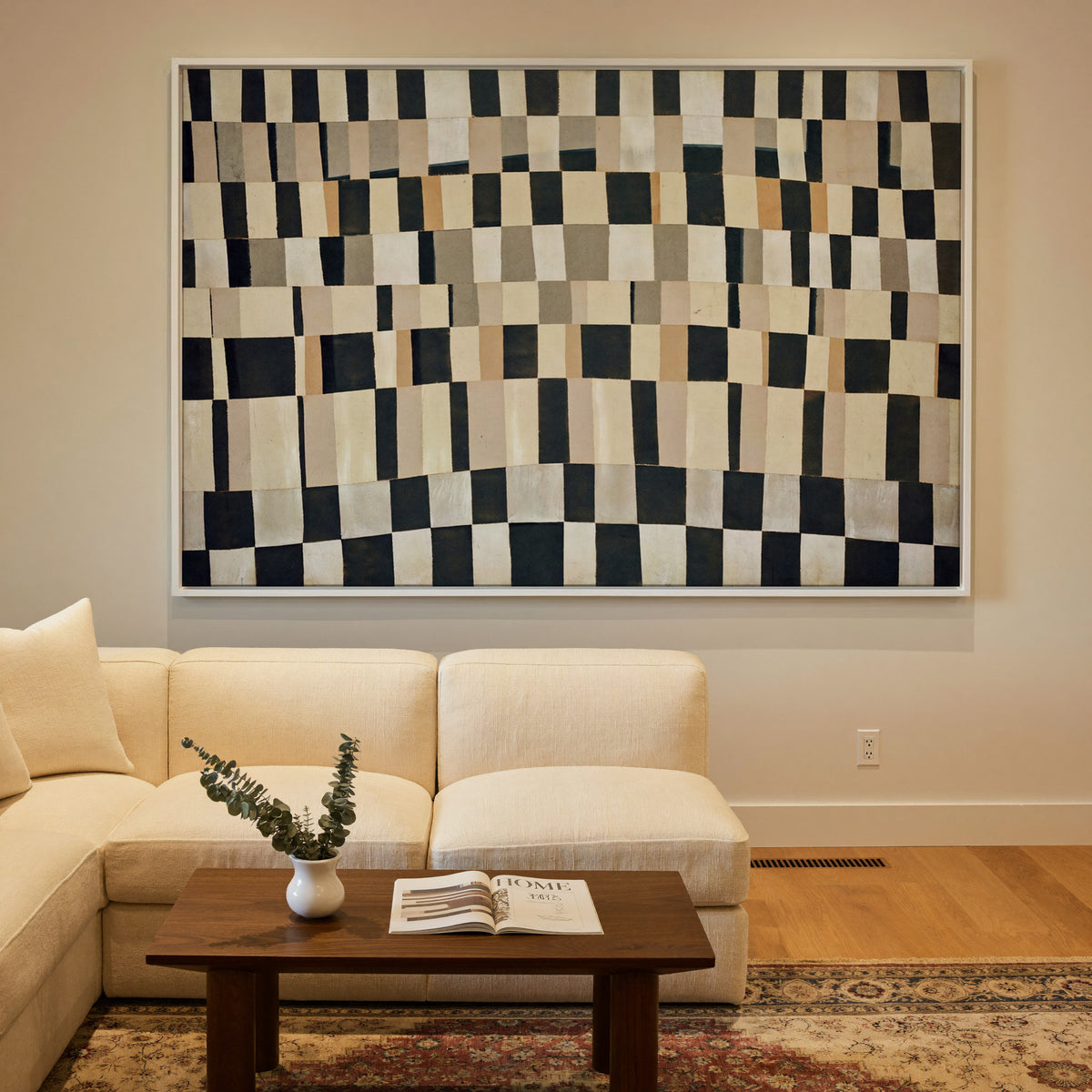 curved black, cream, and tan checker abstract canvas wall art in a white frame in a styled room setting
