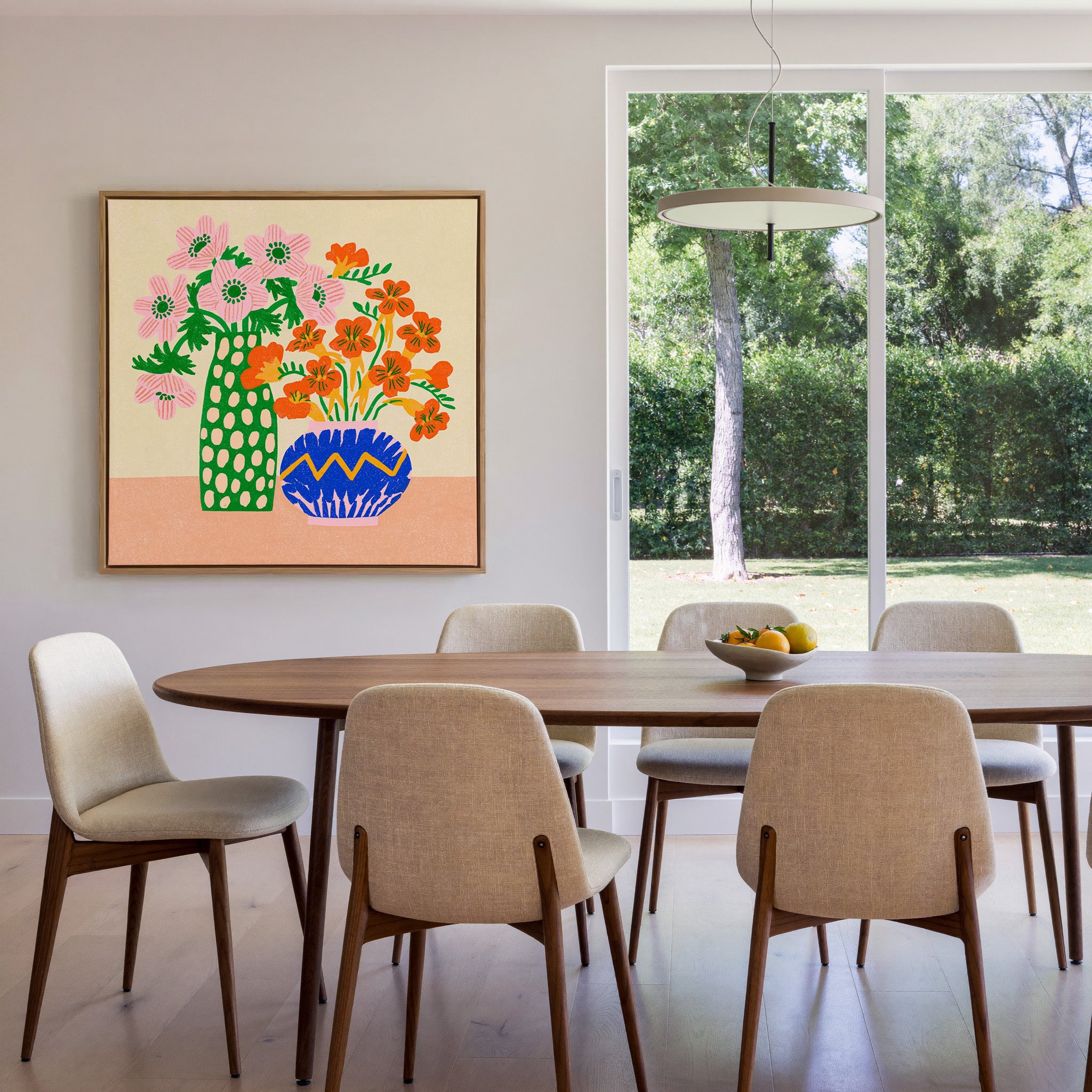 colorful folk still life with pink flowers, canvas wall art in an oak frame in a dining room