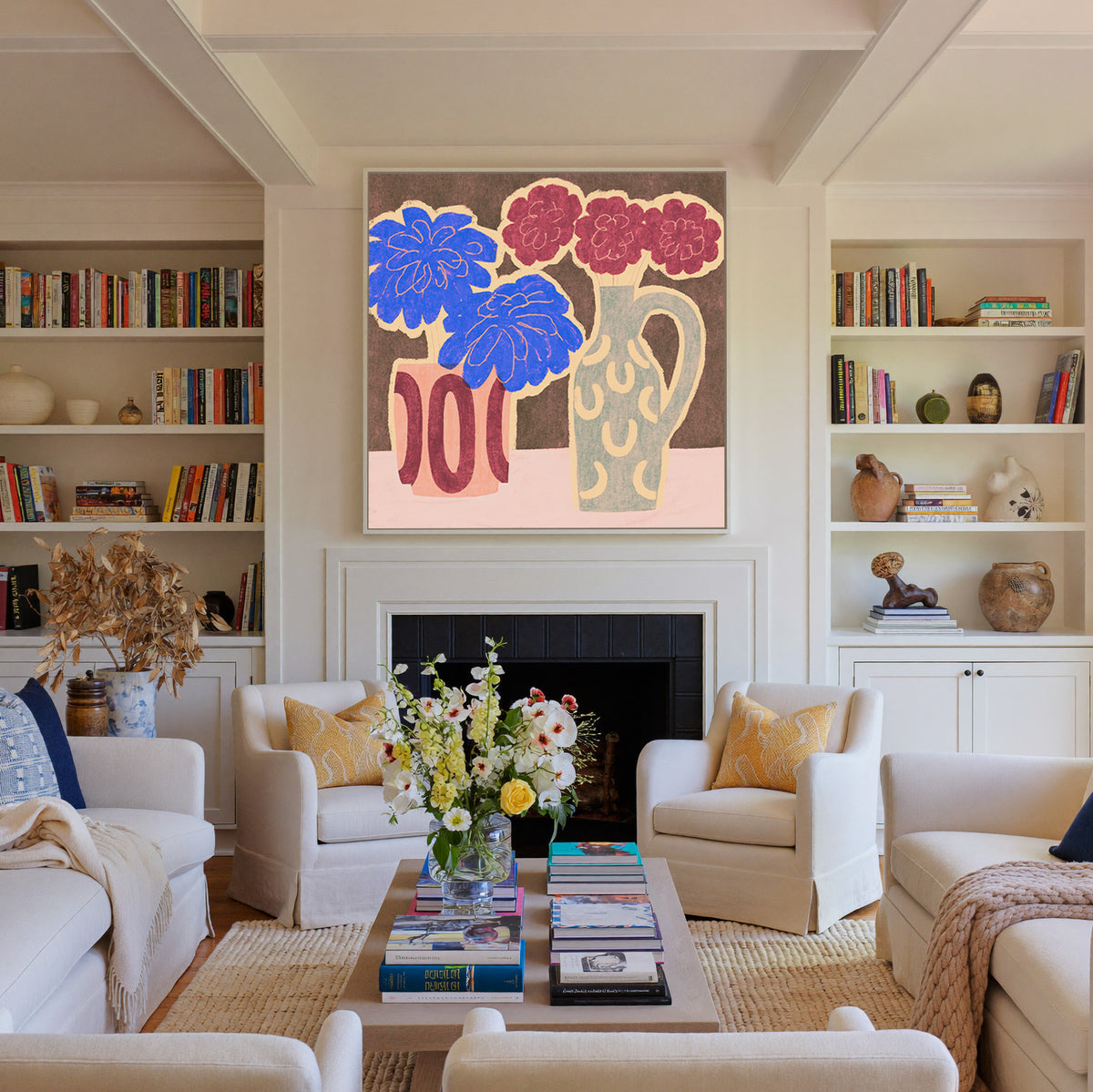 bold blue and burgundy flowers in patterned canvas wall art in a white frame above a fireplace