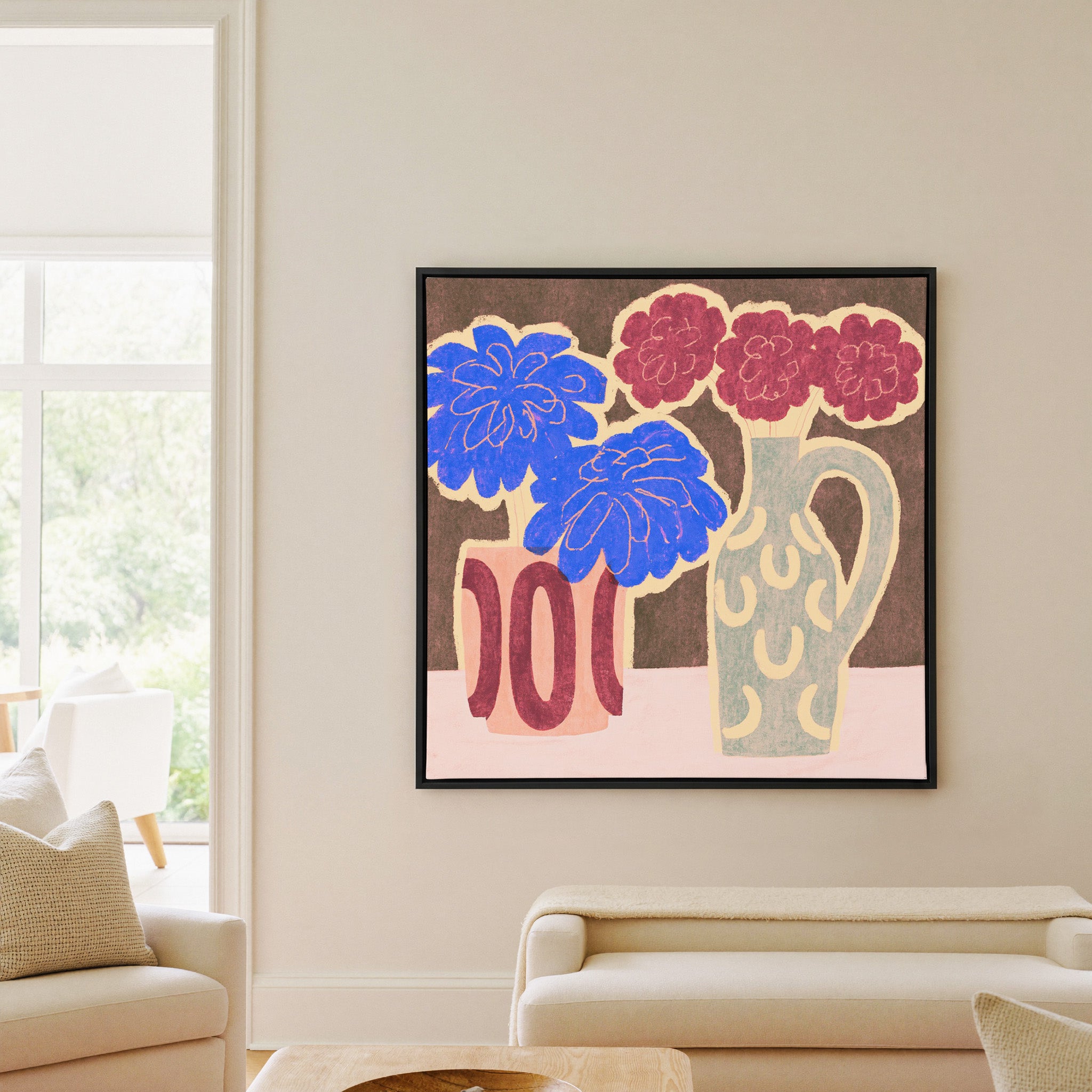 bold blue and burgundy flowers in patterned canvas wall art in a black frame in a living room