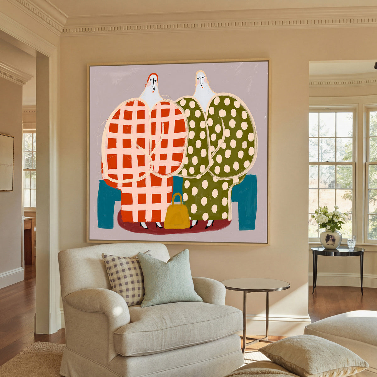 two stylized figures in check and polka dot canvas wall art in a natural wood frame in a styled room setting