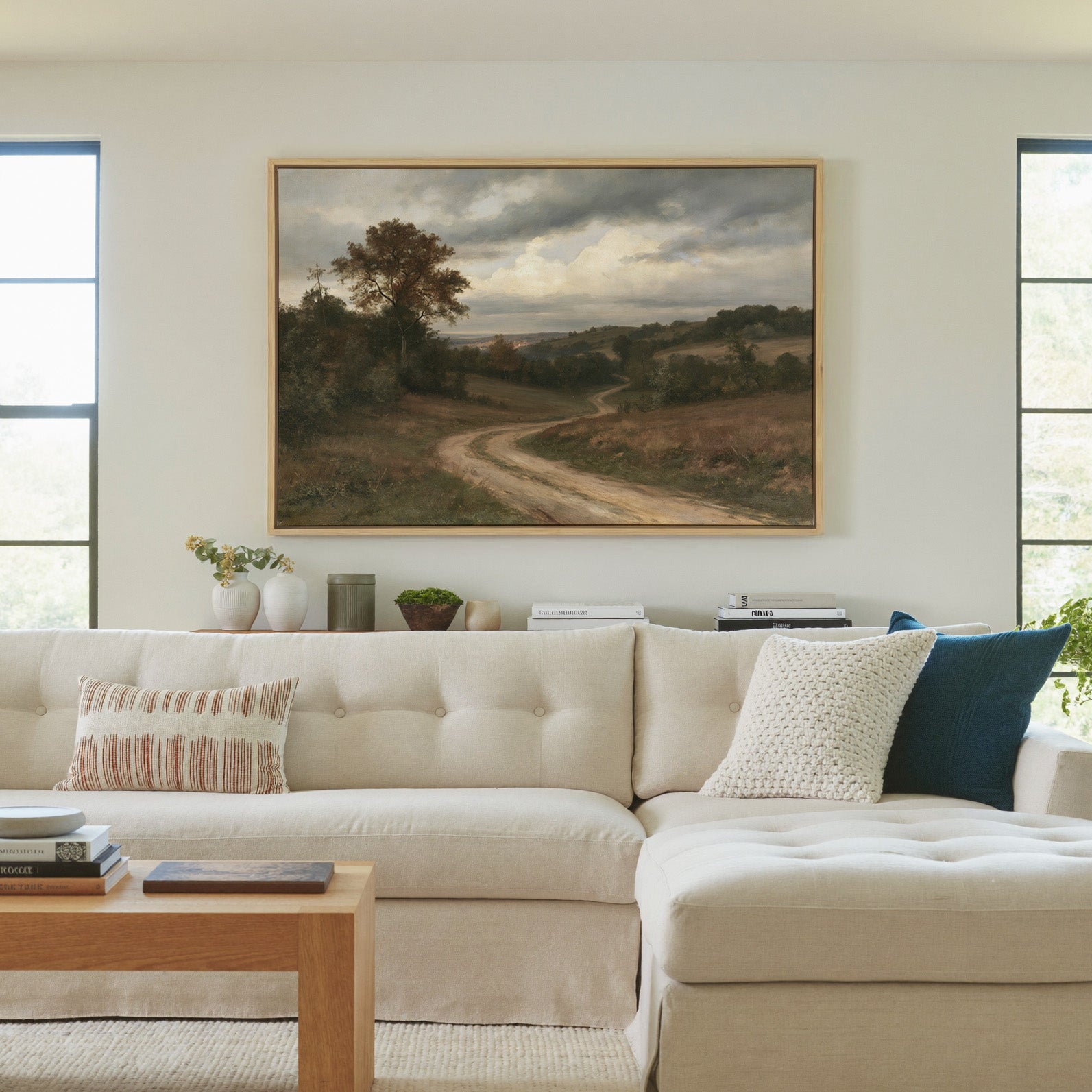 soft brown countryside with a winding dirt road canvas wall art in a natural wood frame in a living room