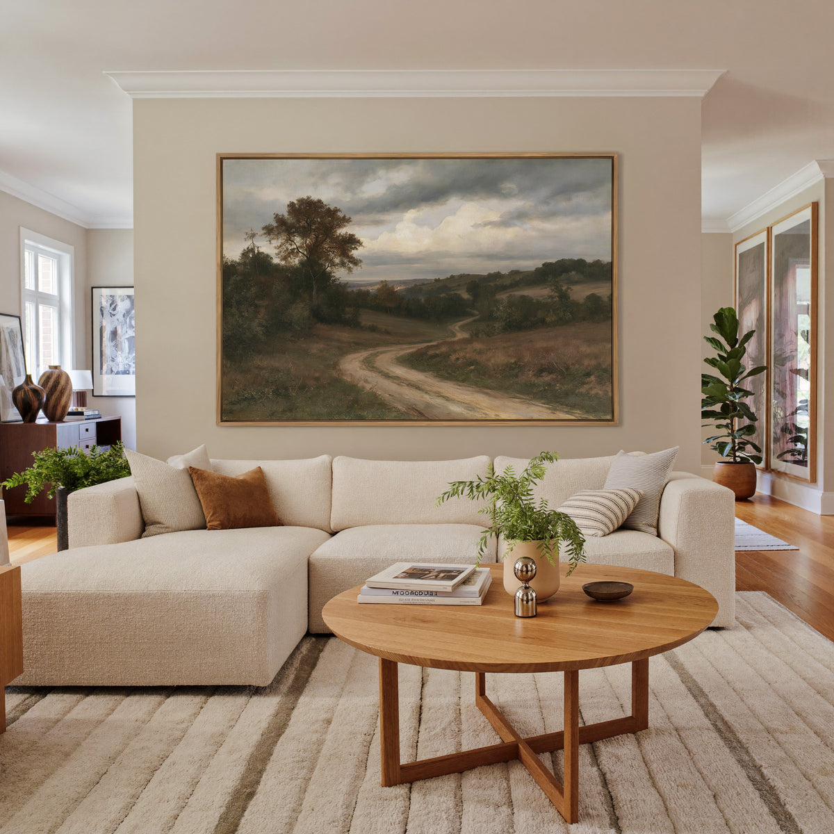 soft brown countryside with a winding dirt road canvas wall art in an oak frame in a living room