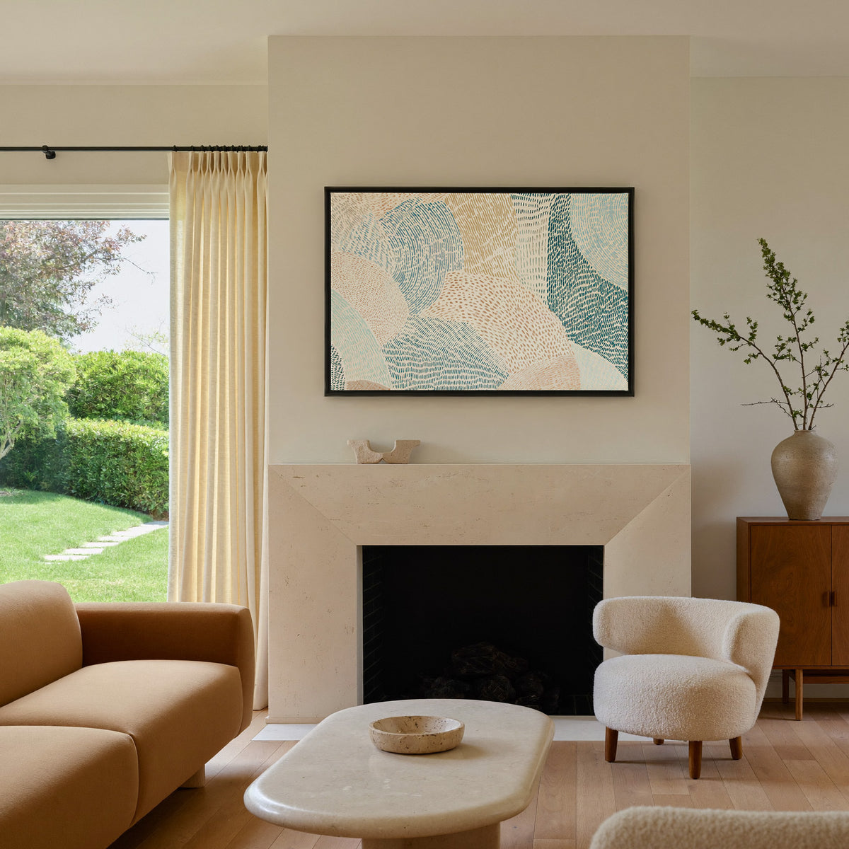 soft coastal abstract with layered teal, aqua, canvas wall art in a black frame above a mantel