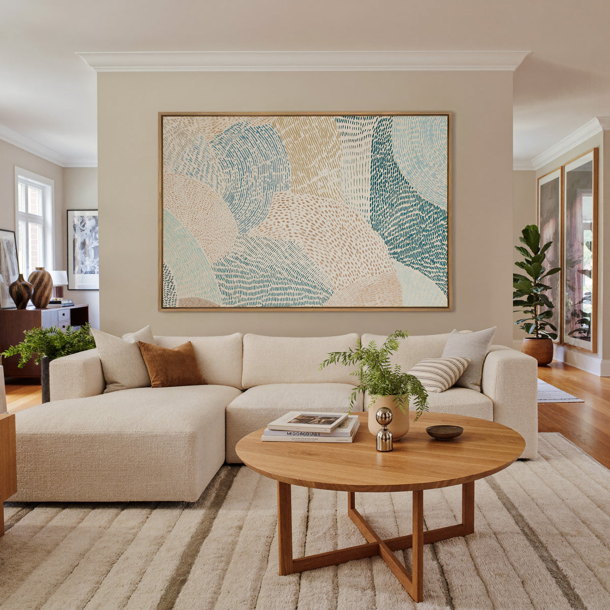 soft coastal abstract with layered teal, aqua, canvas wall art in an oak frame in a living room