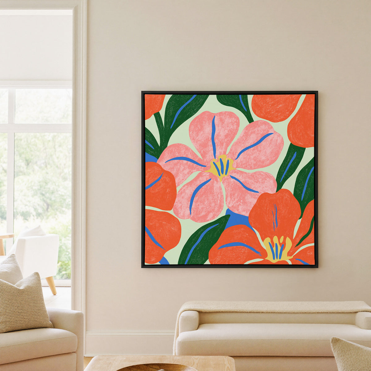 pink and orange floral abstract with blue canvas wall art in a black frame in a living room