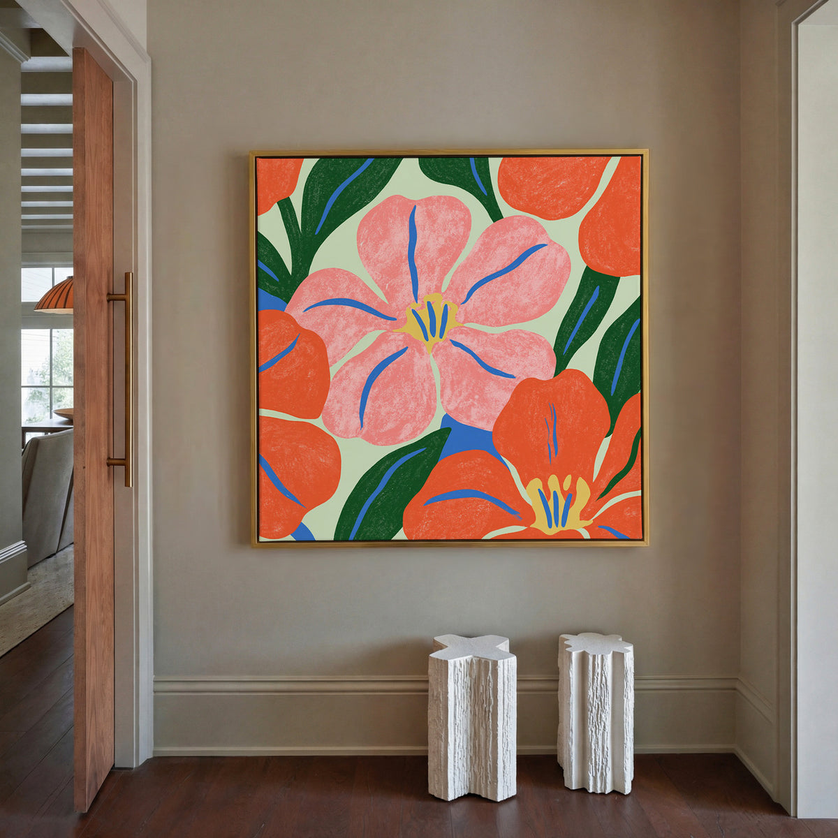 pink and orange floral abstract with blue canvas wall art in a gold frame in a styled room setting