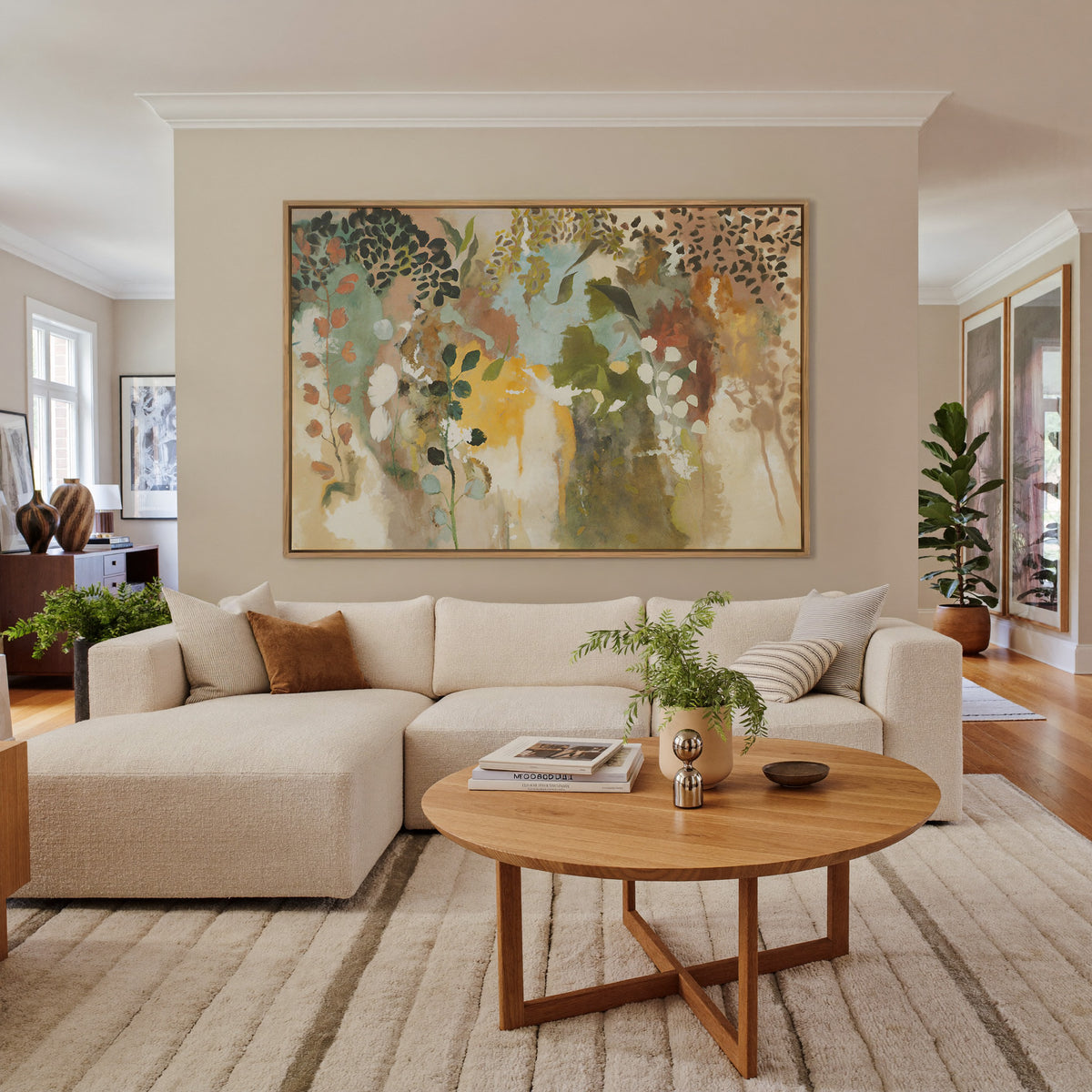 soft botanical abstract with olive, saffron, canvas wall art in an oak frame in a living room