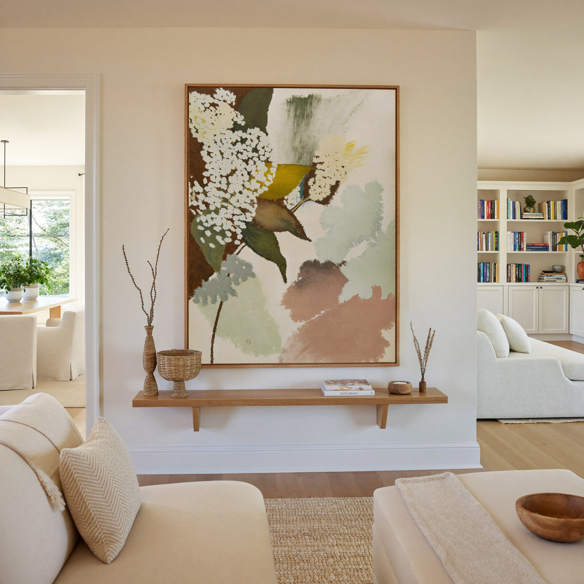soft botanical abstract with pale green, blush, canvas wall art in an oak frame in a living room