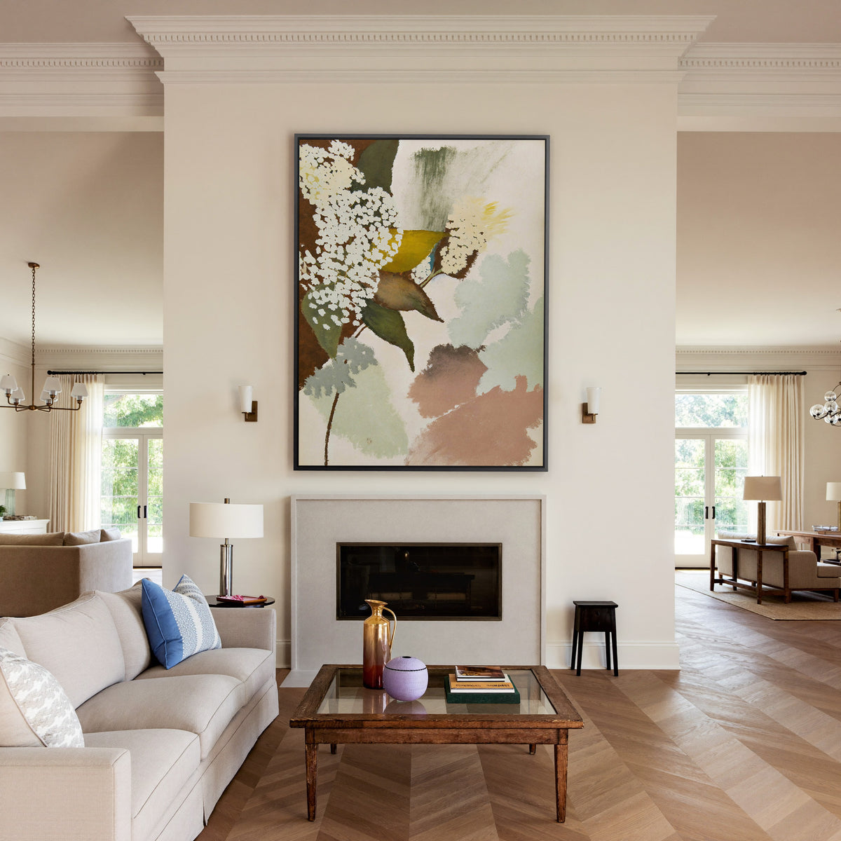 soft botanical abstract with pale green, blush, canvas wall art in a black frame above a mantel
