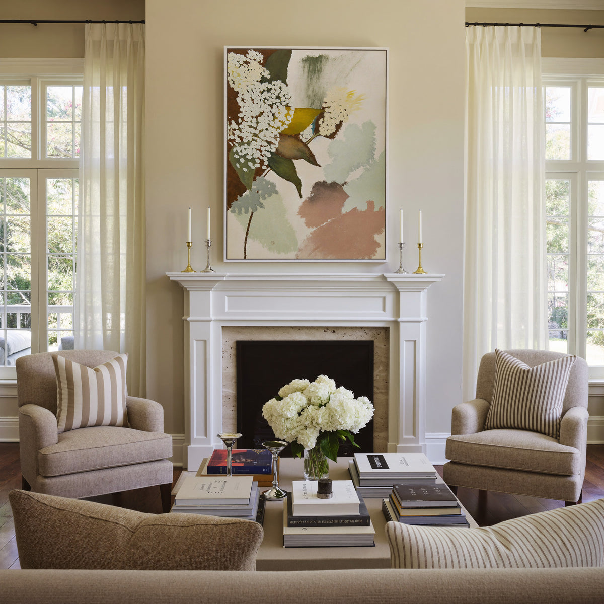 soft botanical abstract with pale green, blush, canvas wall art in a white frame above a mantel